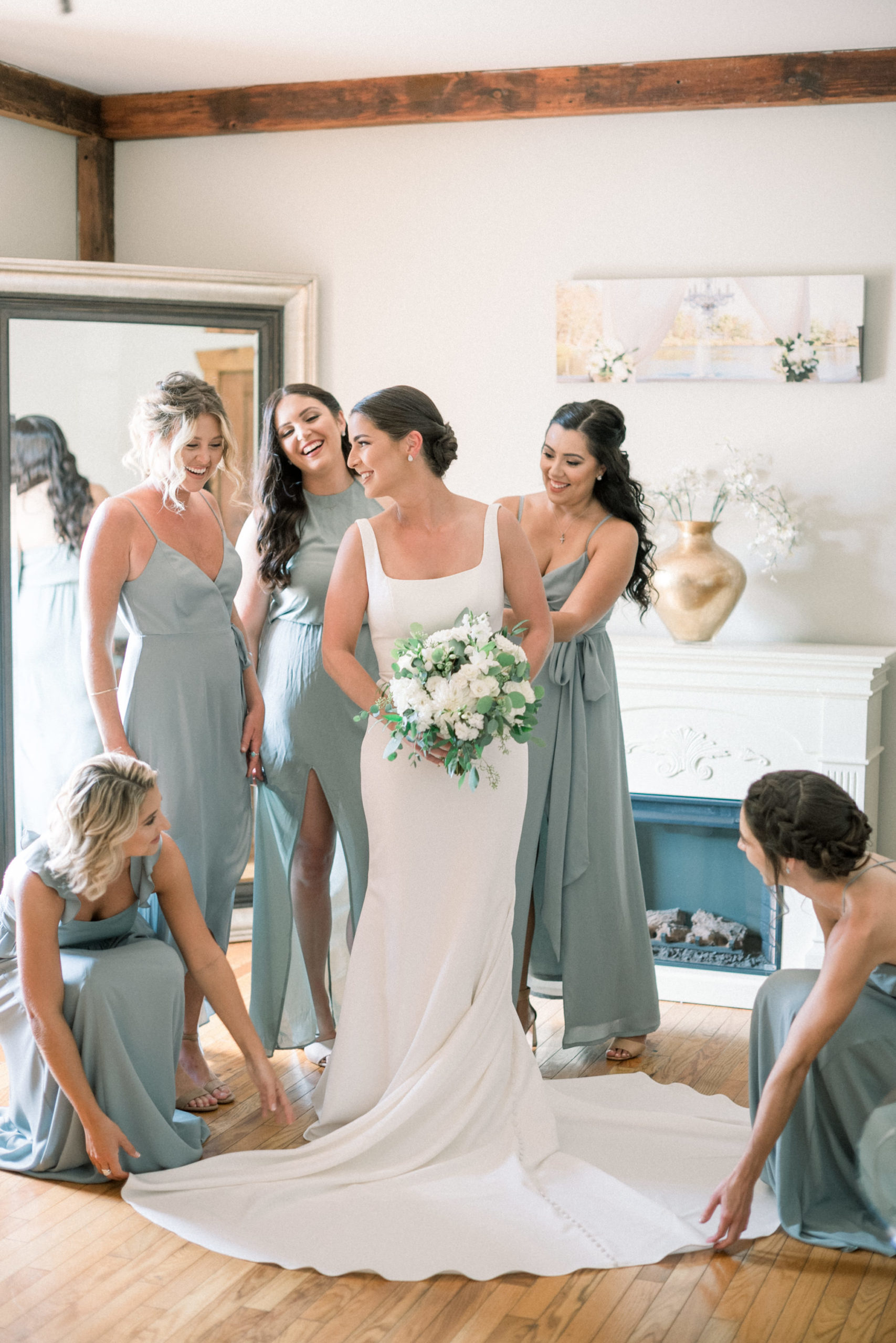 bride getting ready with her best friends and bridesmaids in the bridal suite of her wedding venue