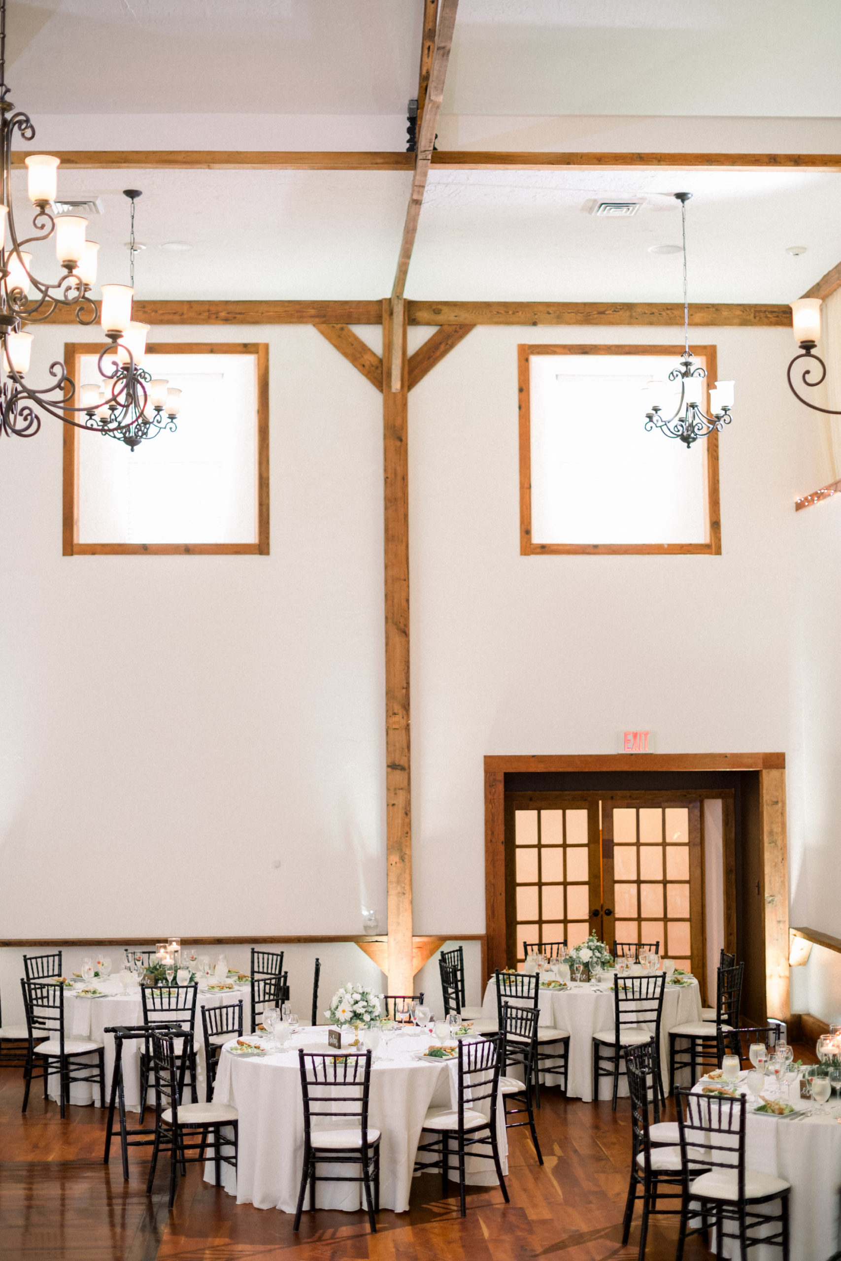 reception hall with wooden exposed beams throughout with tall walls and high ceilings for luxurious weddings