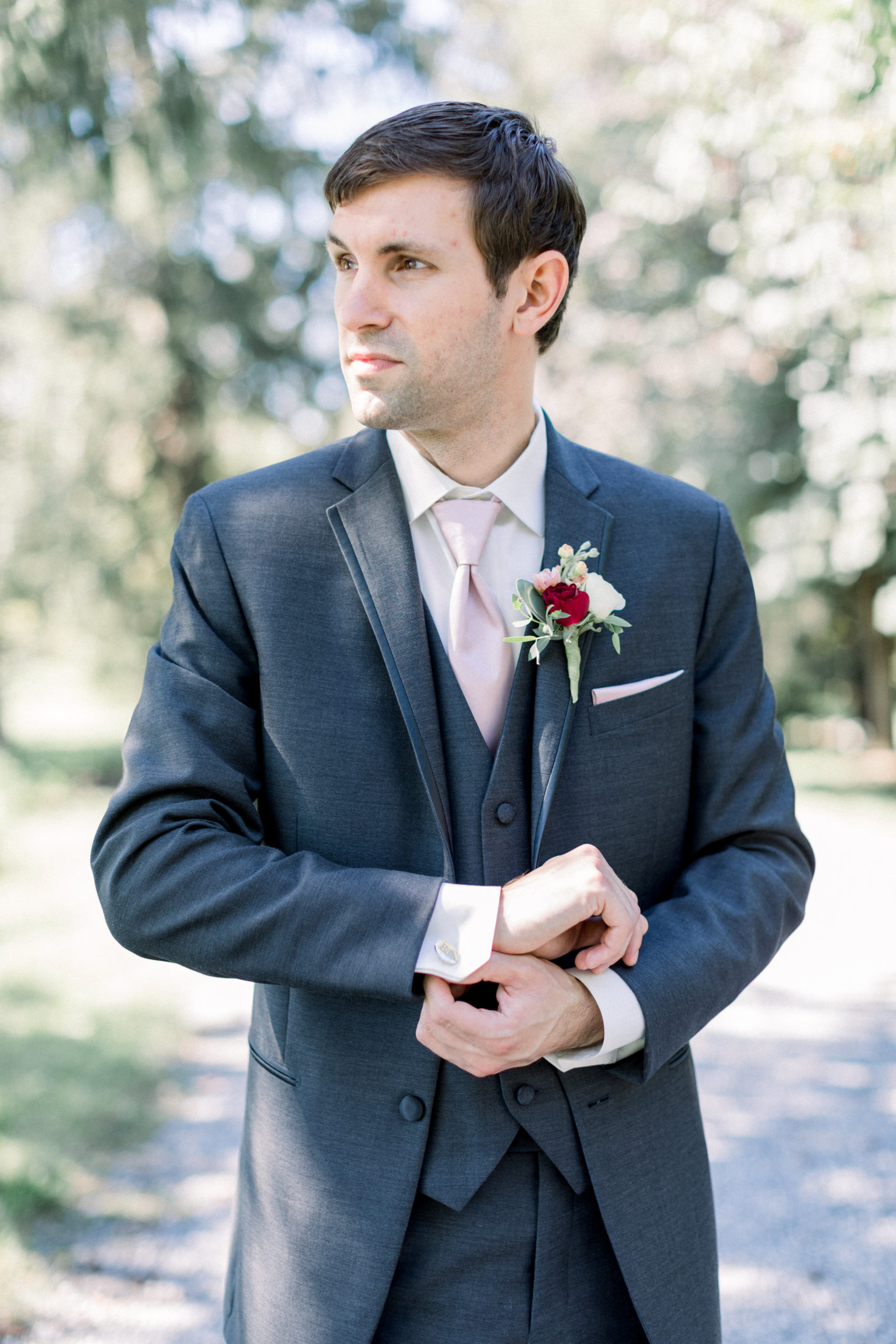 groom adjusting cufflinks on jacket before chic Howard county conservancy wedding