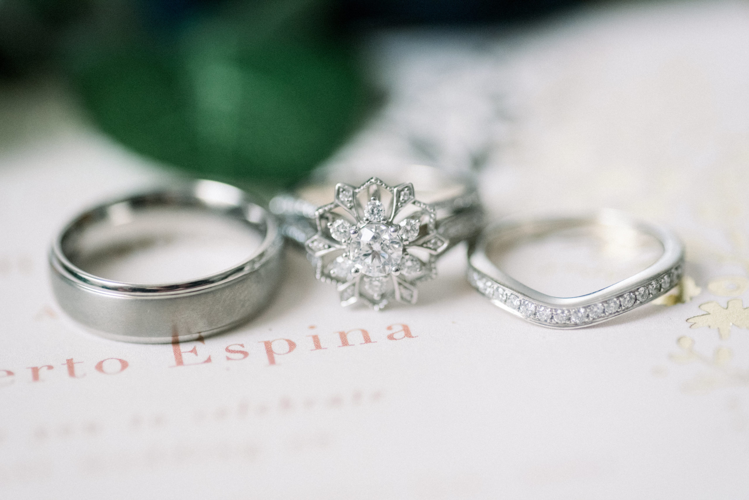 close up of white gold wedding bands, and engagement ring