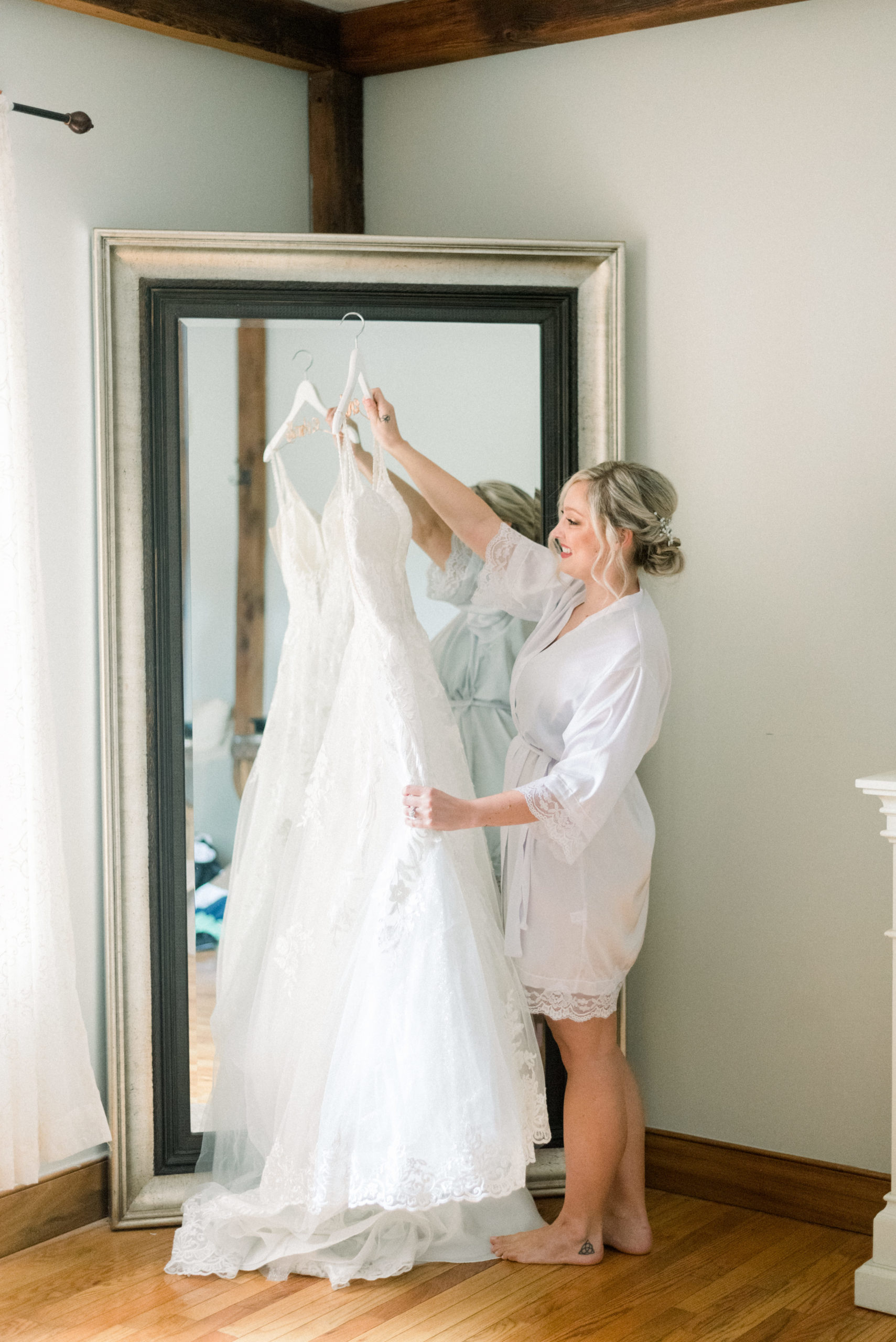 bride holding up wedding dress