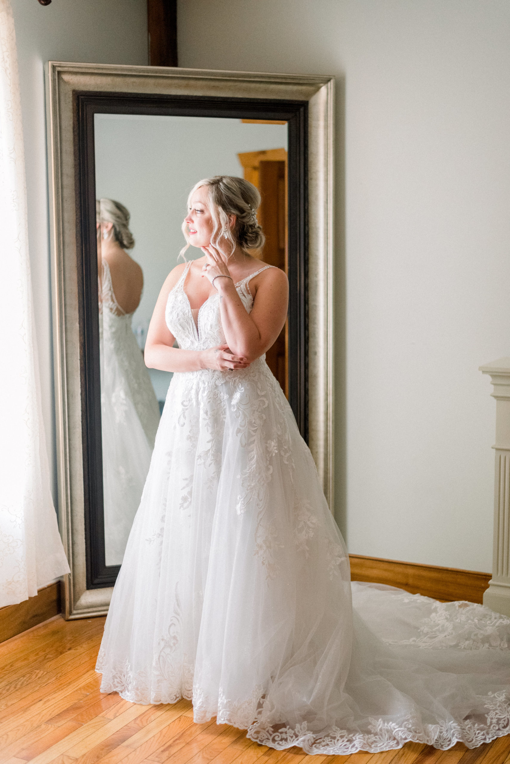 bride waiting for wedding ceremony to begin while wearing a-line white wedding dress