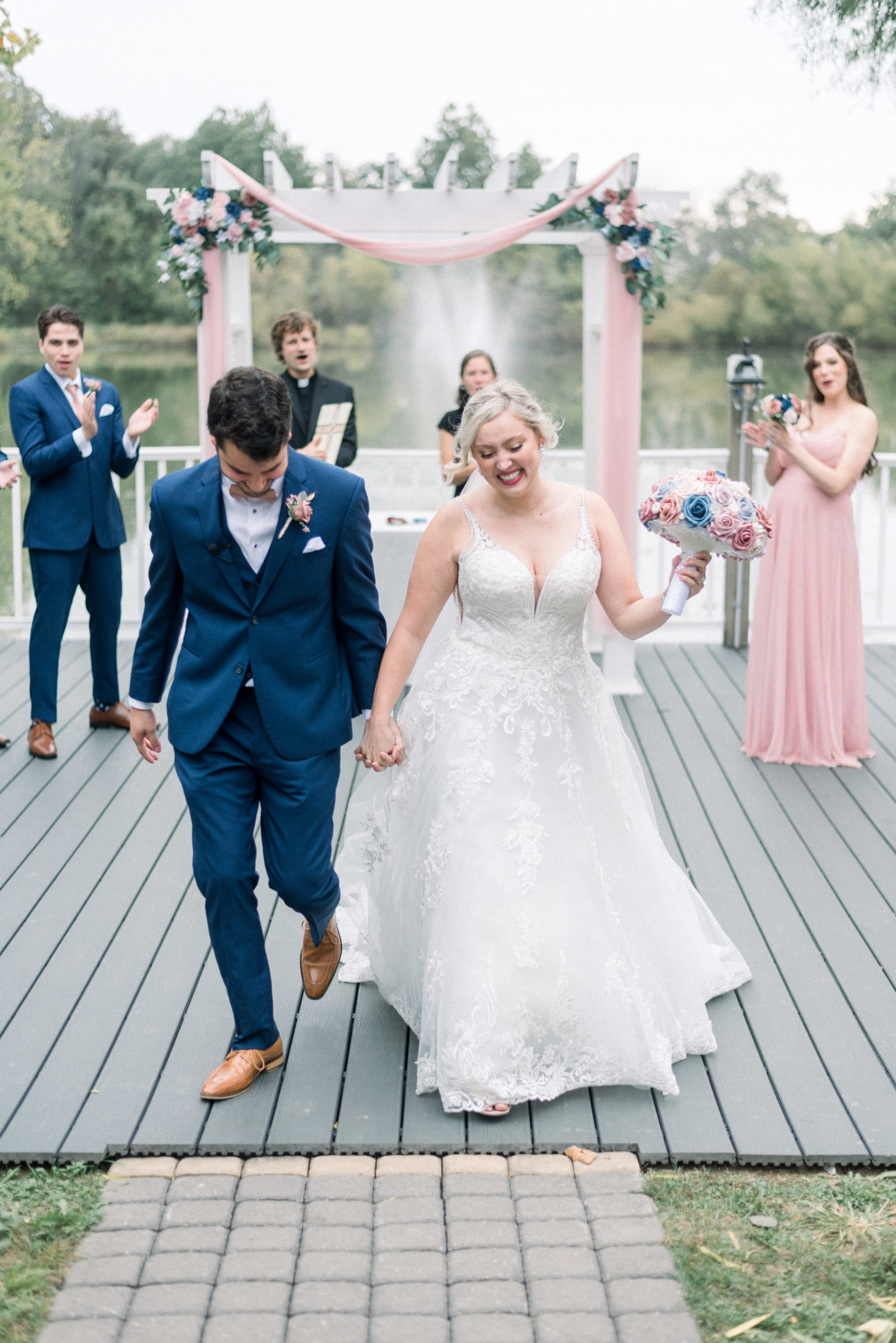 wedding couple celebrating recent marriage and walking out of ceremony hand in hand