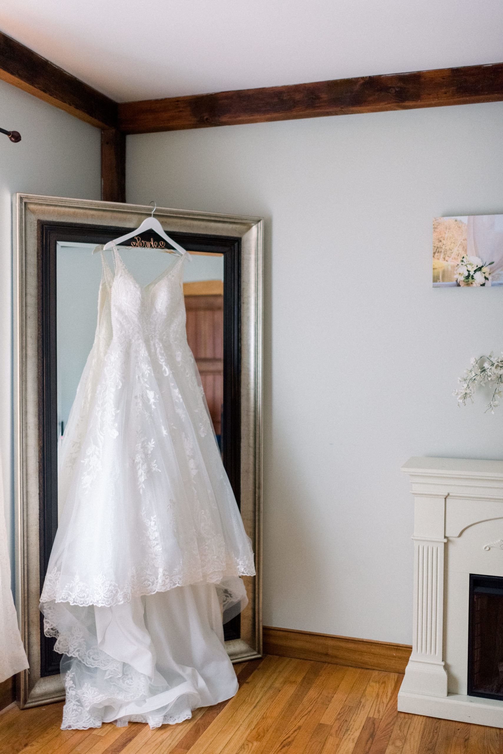 wedding dress hanging from mirror before stunning lodges at gettysburg wedding ceremony