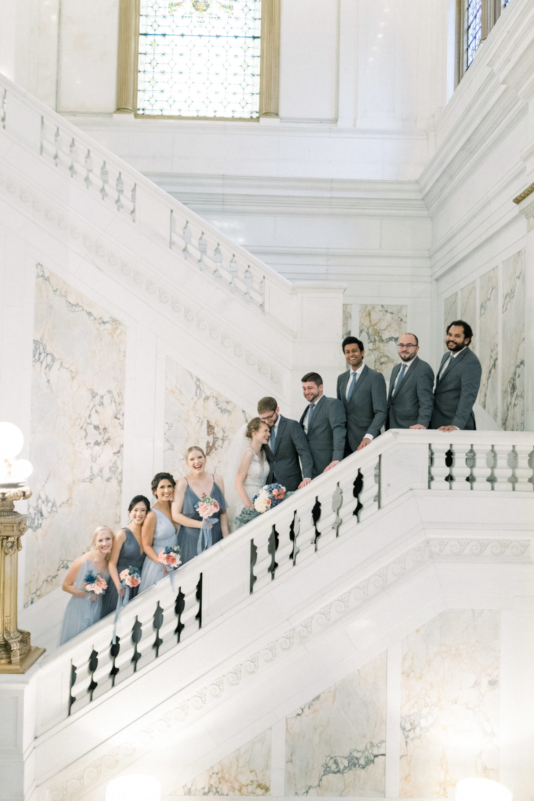 bridal party standing on stairs before wedding