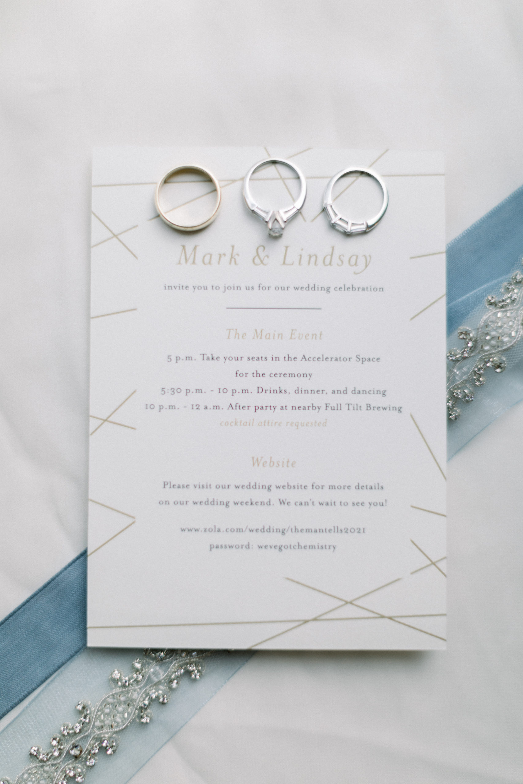 wedding rings sitting on wedding invitations