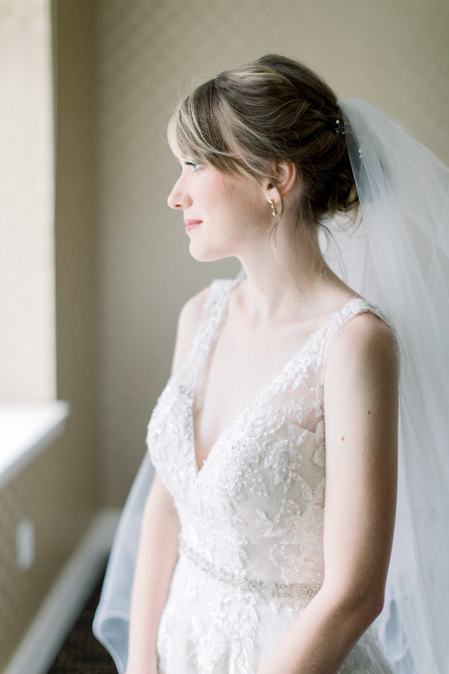 bride looking outside window before elegantly Modern Accelerator Baltimore Wedding