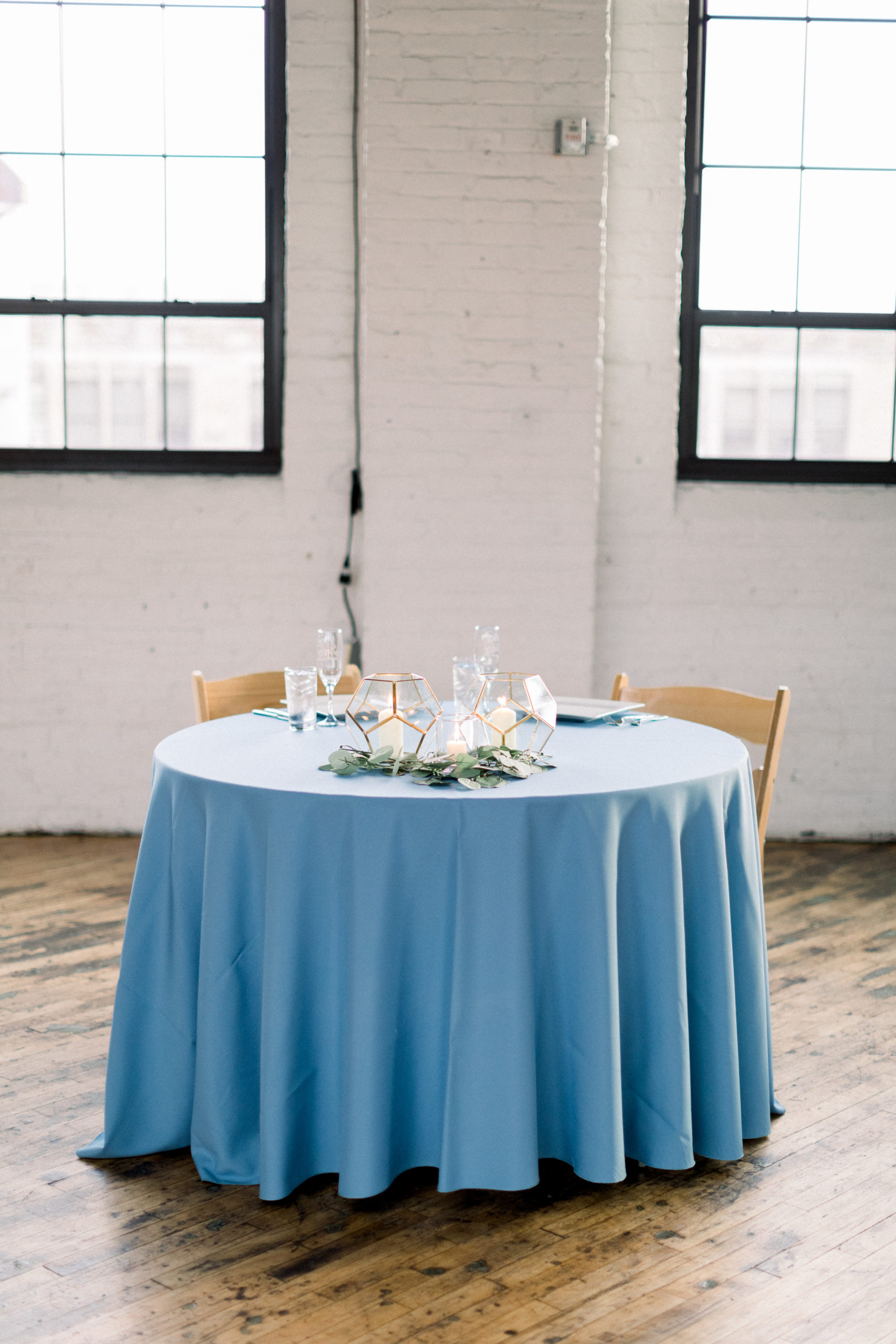 sweethearts table with blue tablecloth and plates
