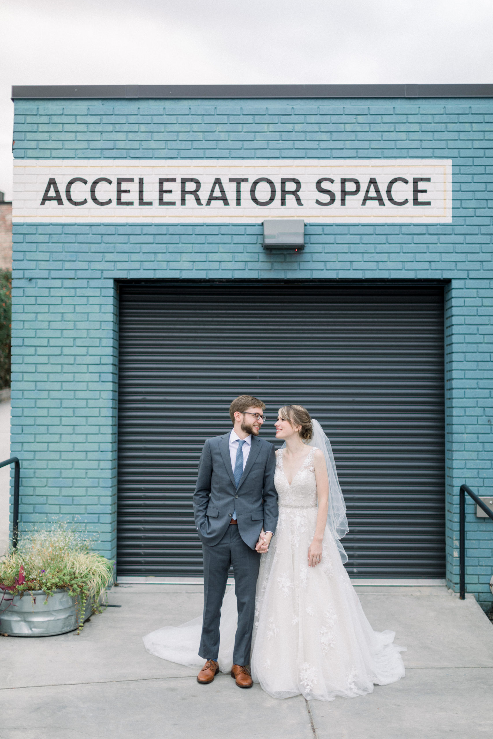 couple holding hands and looking at one another after elegantly Modern Accelerator Baltimore Wedding