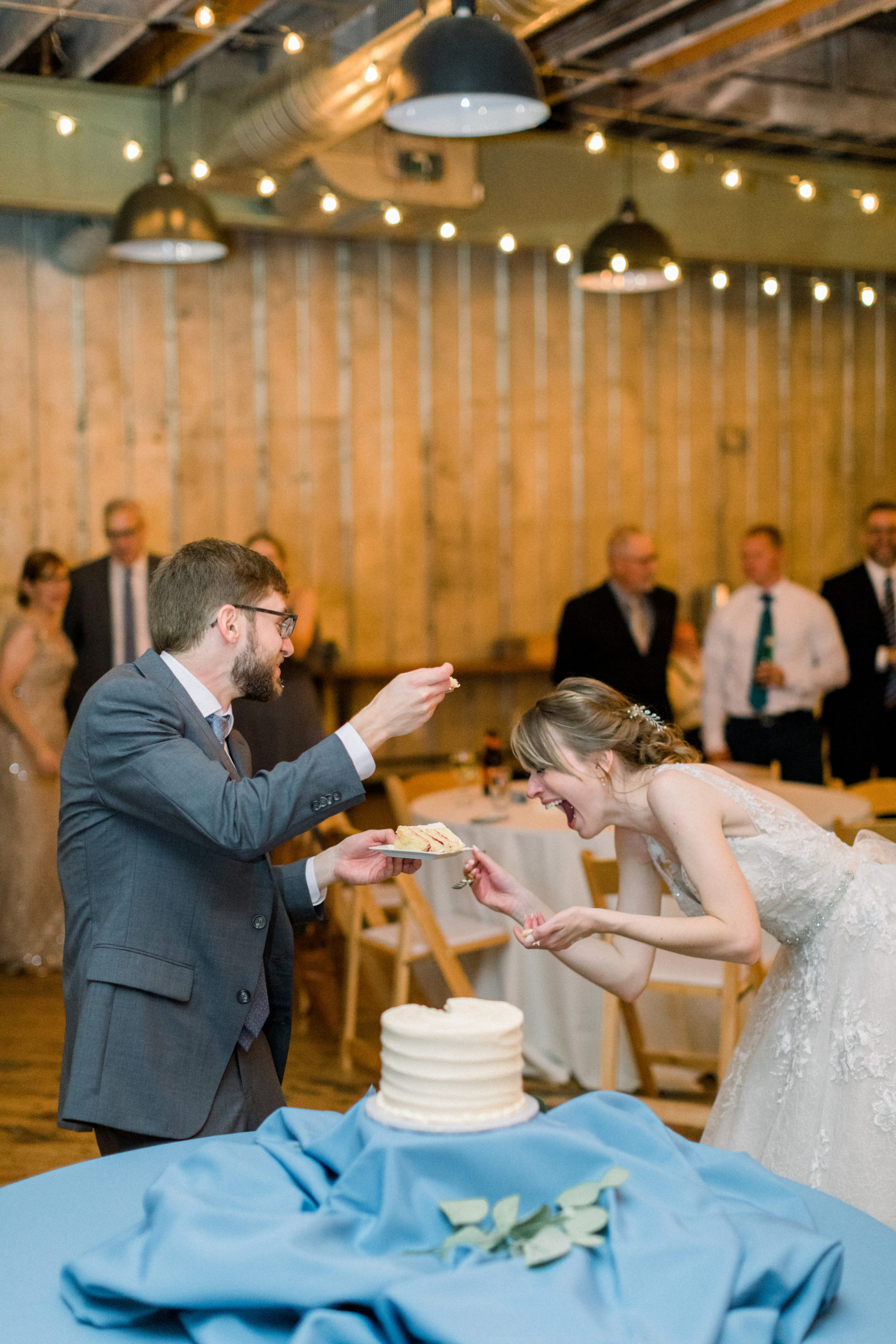 bride and groom laughing during cake cutting