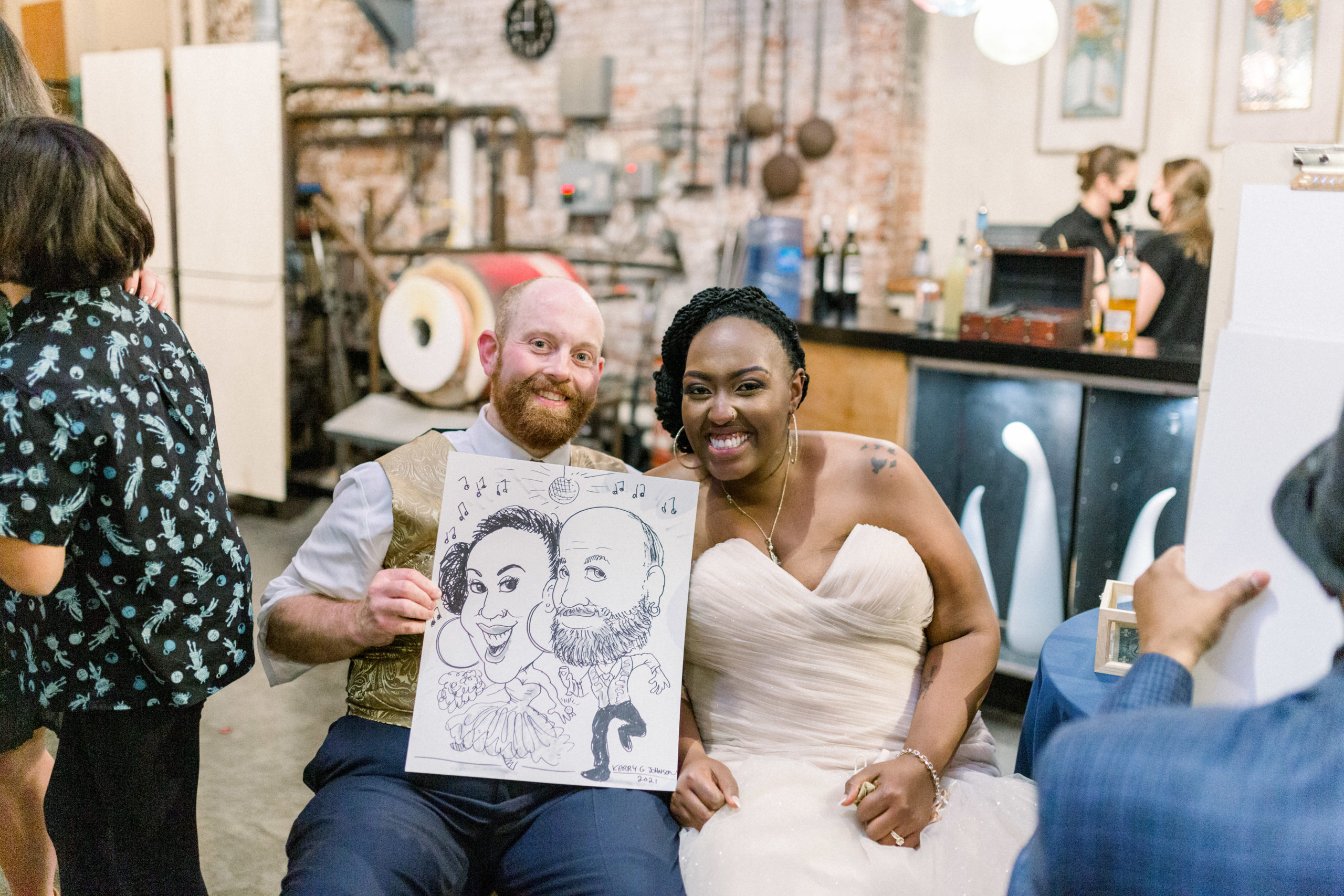newly married couple showing caricature at Romantic Fall Baltimore Wedding reception