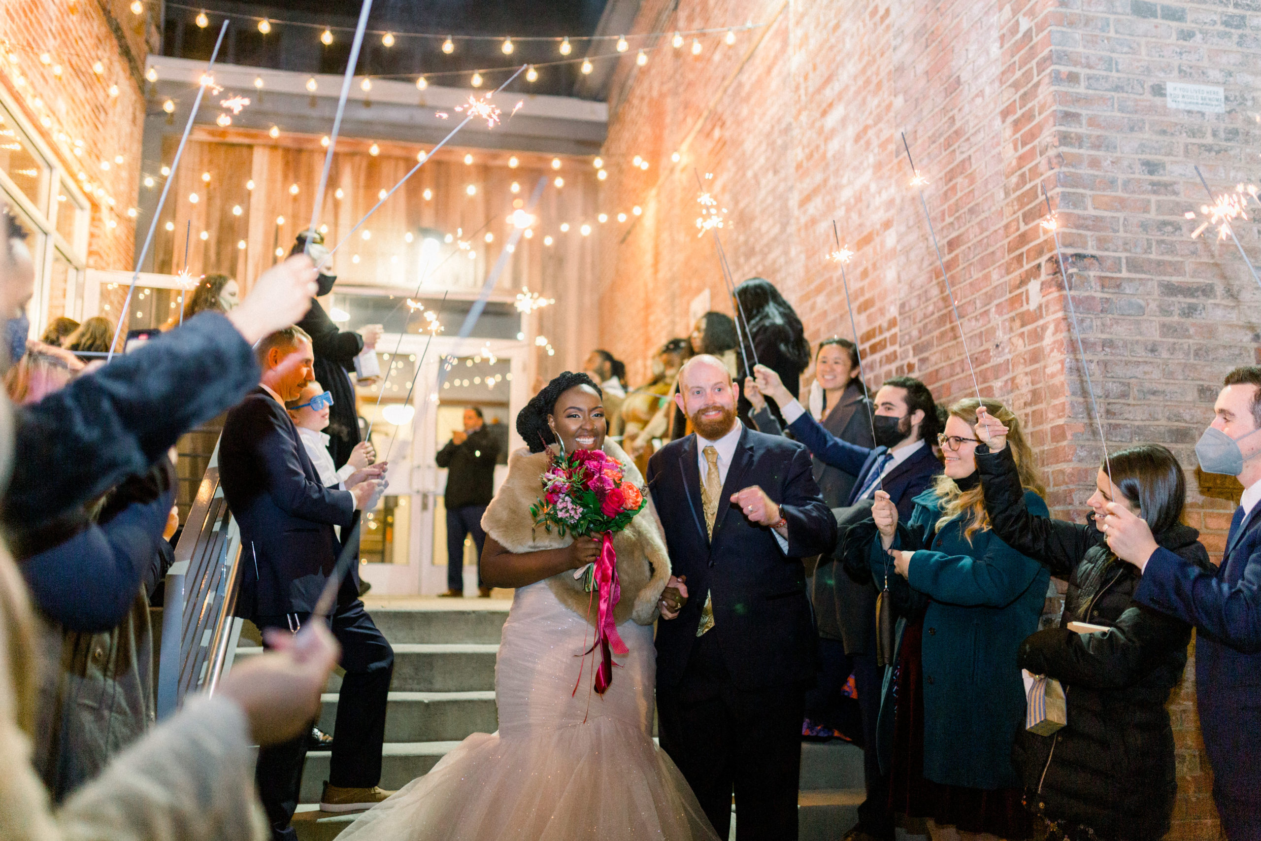 bride and groom leaving Romantic Fall Baltimore Wedding through sparkler exit