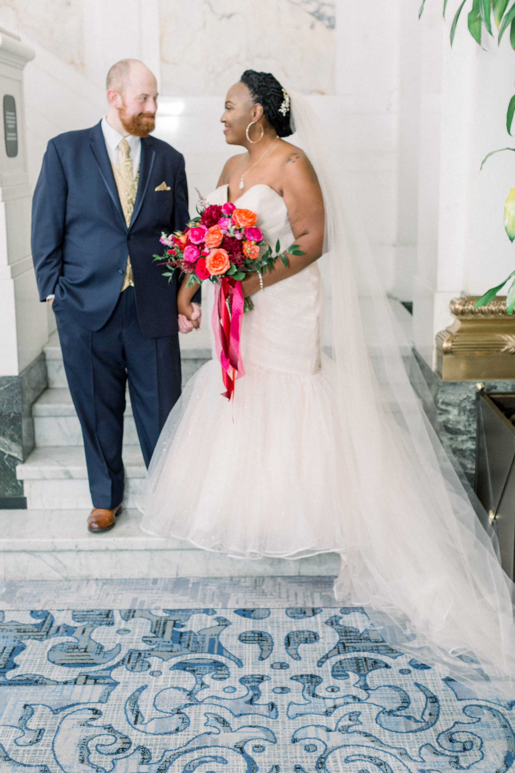 bride and groom holding hands at stairs before Romantic Fall Baltimore Wedding