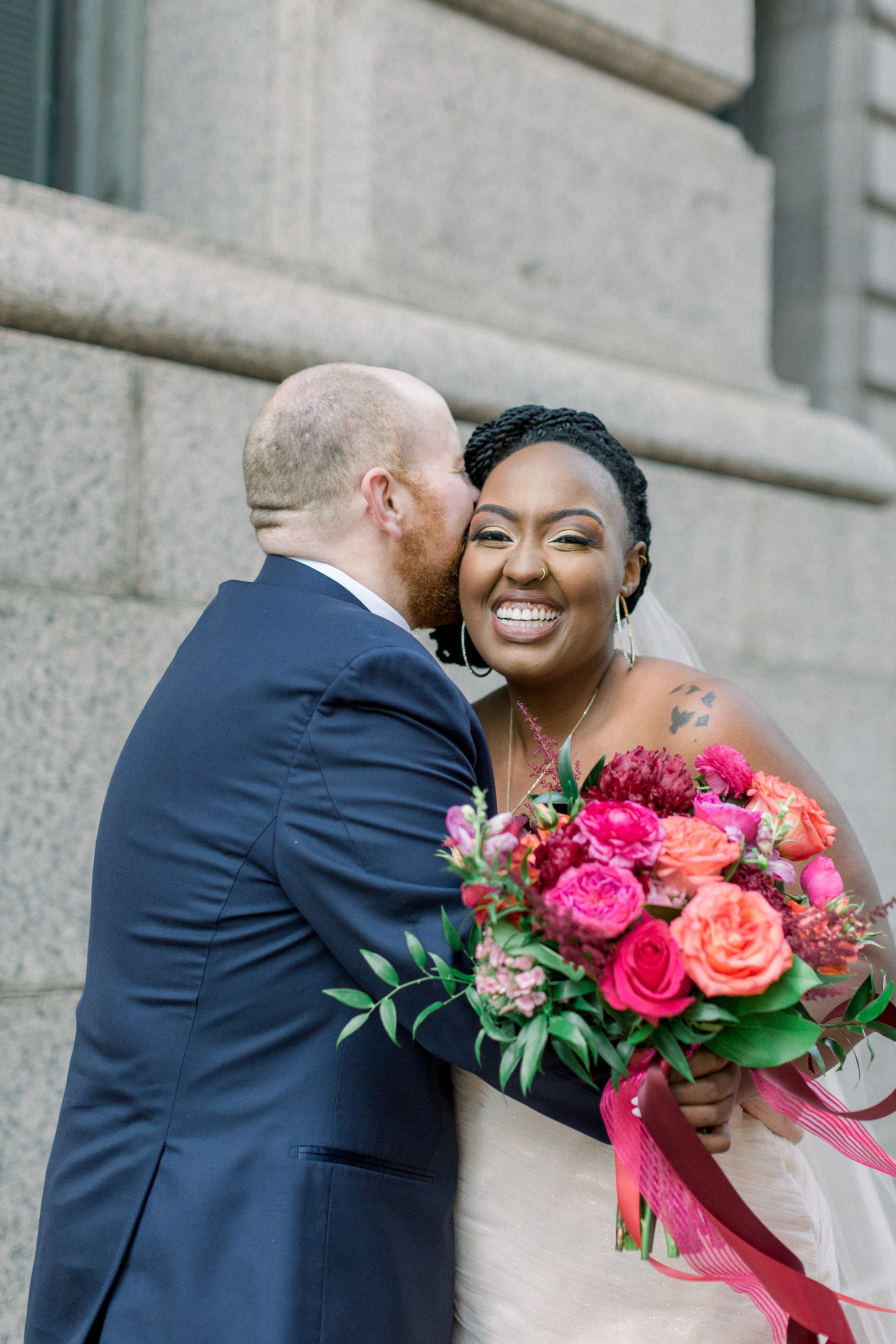groom kissing bride's cheek during portraits after Romantic Fall Baltimore Wedding