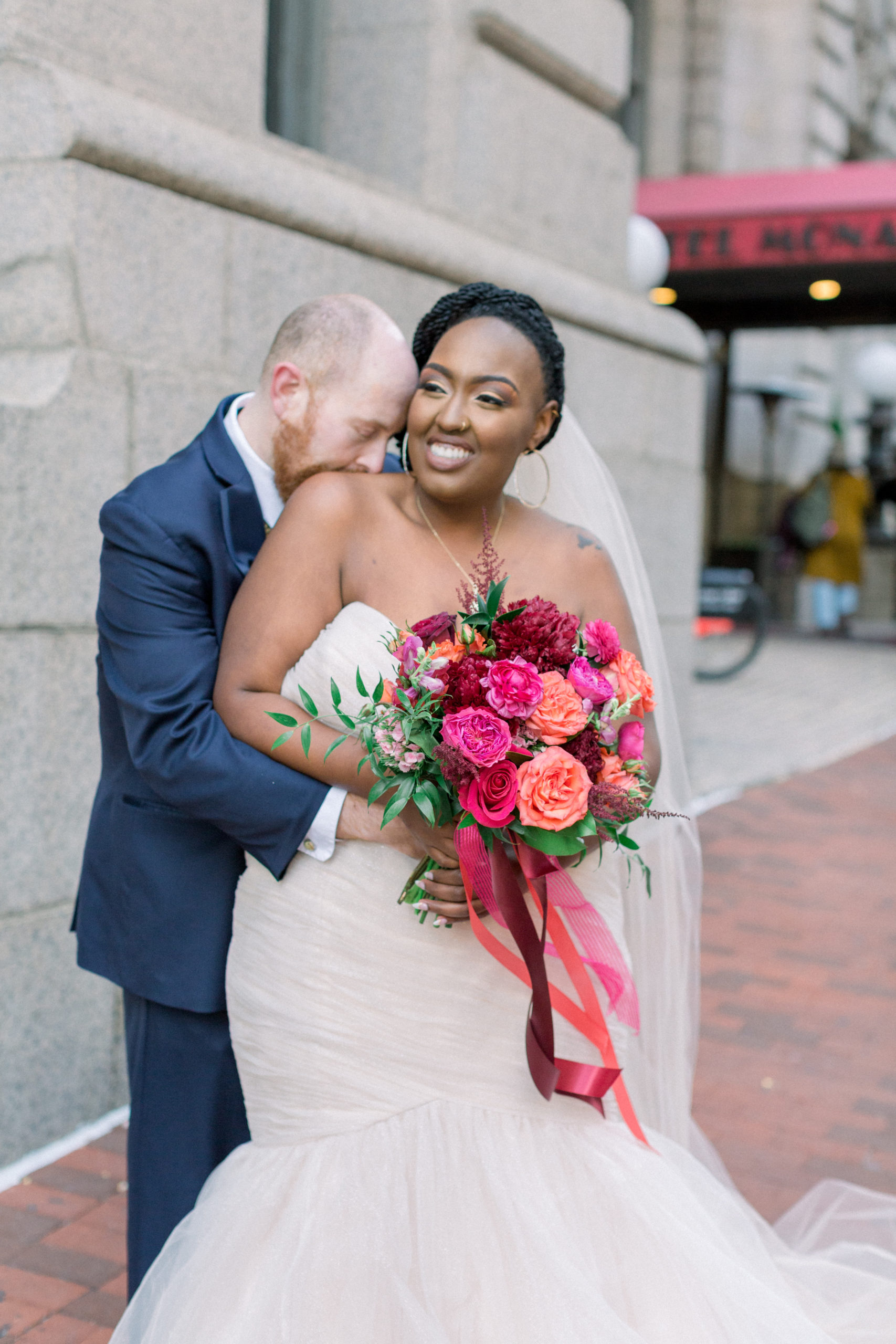 couple embracing and laughing during portraits after Romantic Fall Baltimore Wedding