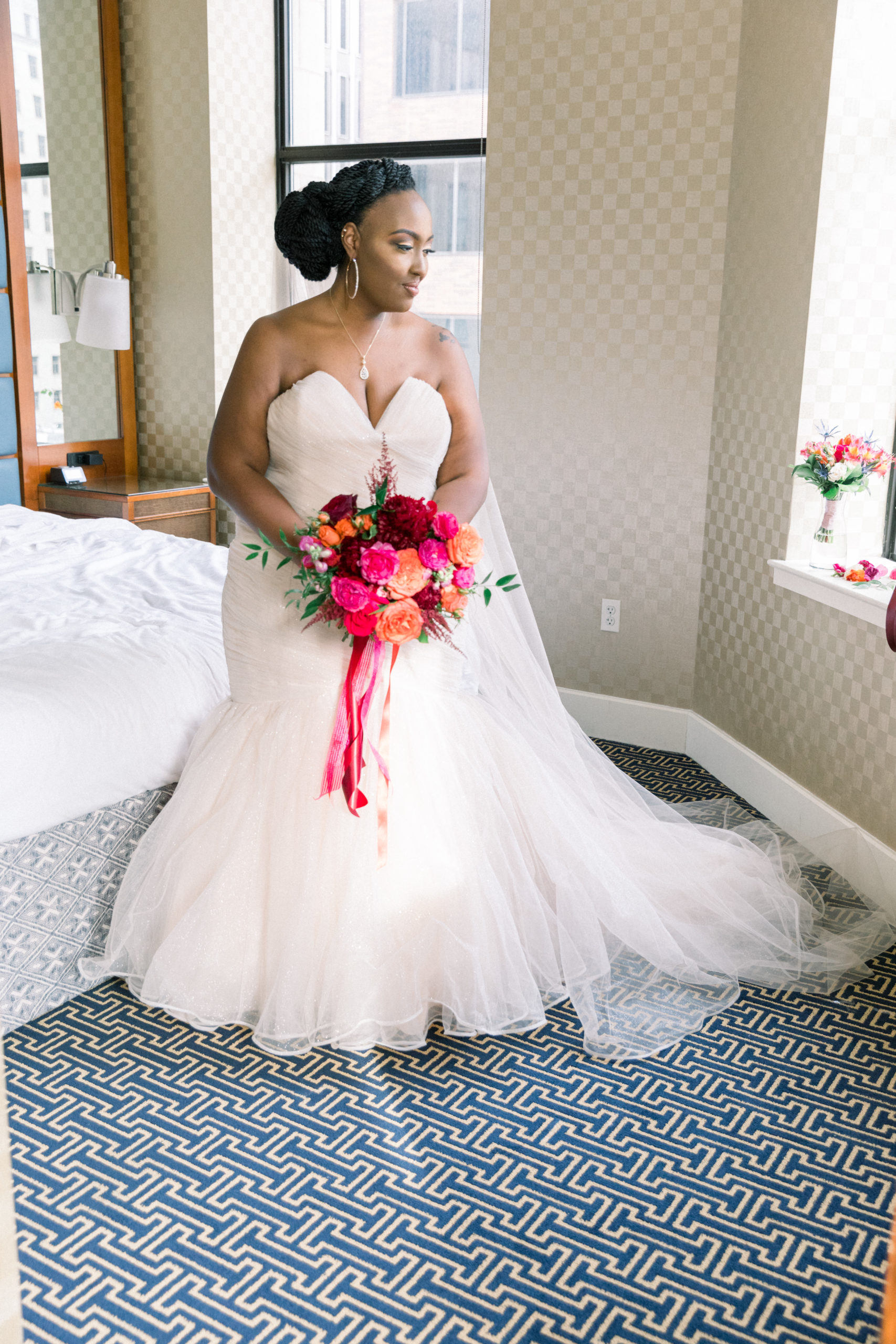 bride holding bouquet looking out window before Romantic Fall Baltimore Wedding