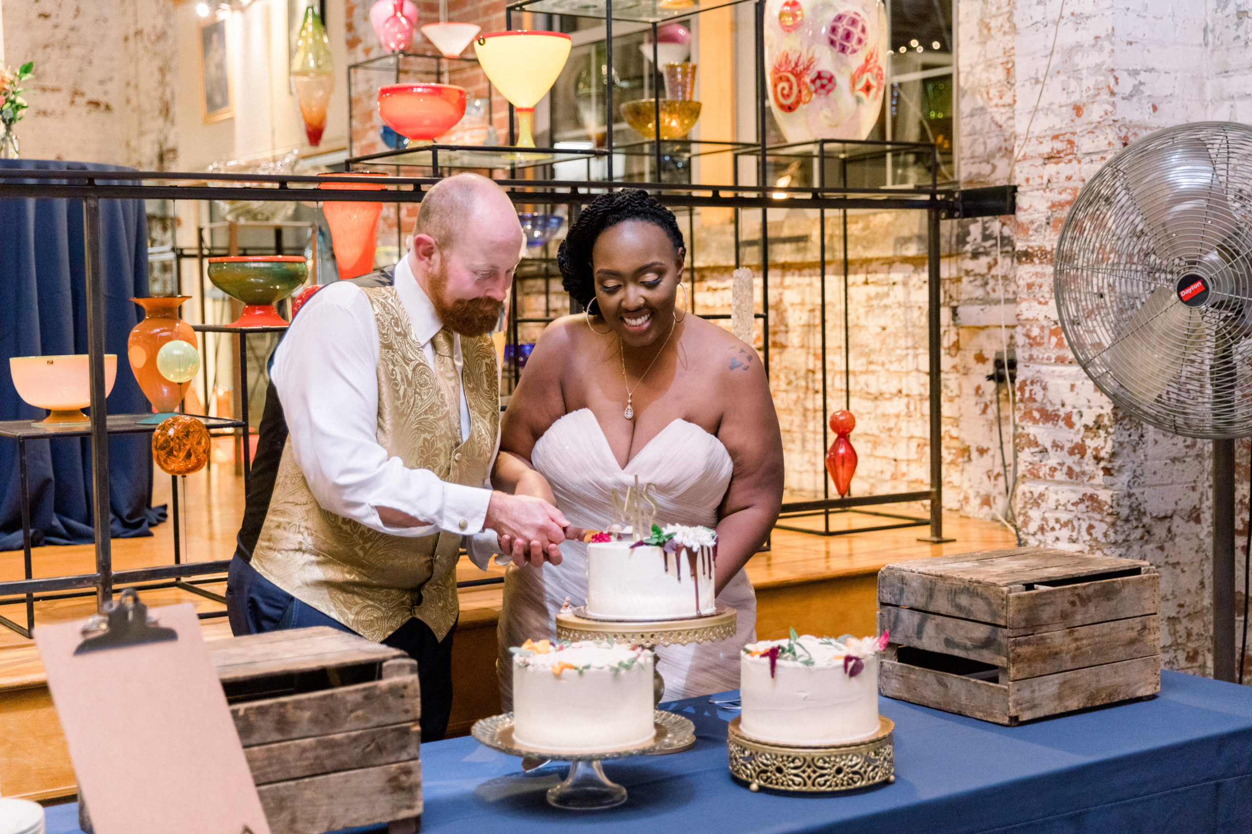 bride and groom cutting cake during Romantic Fall Baltimore Wedding reception