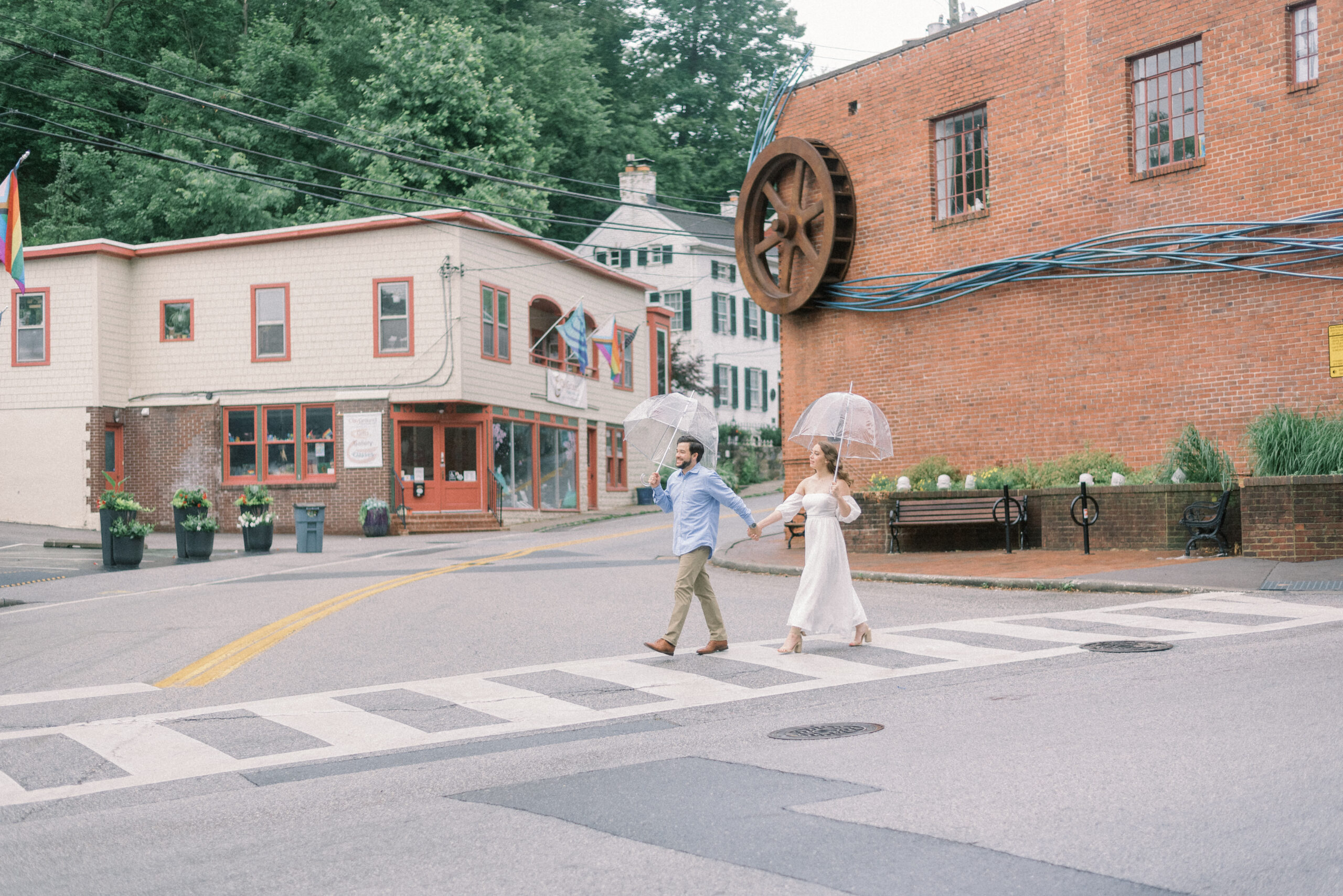 Maryland wedding photographer captures couple walking across the strreet during Old Ellicott City engagement photos