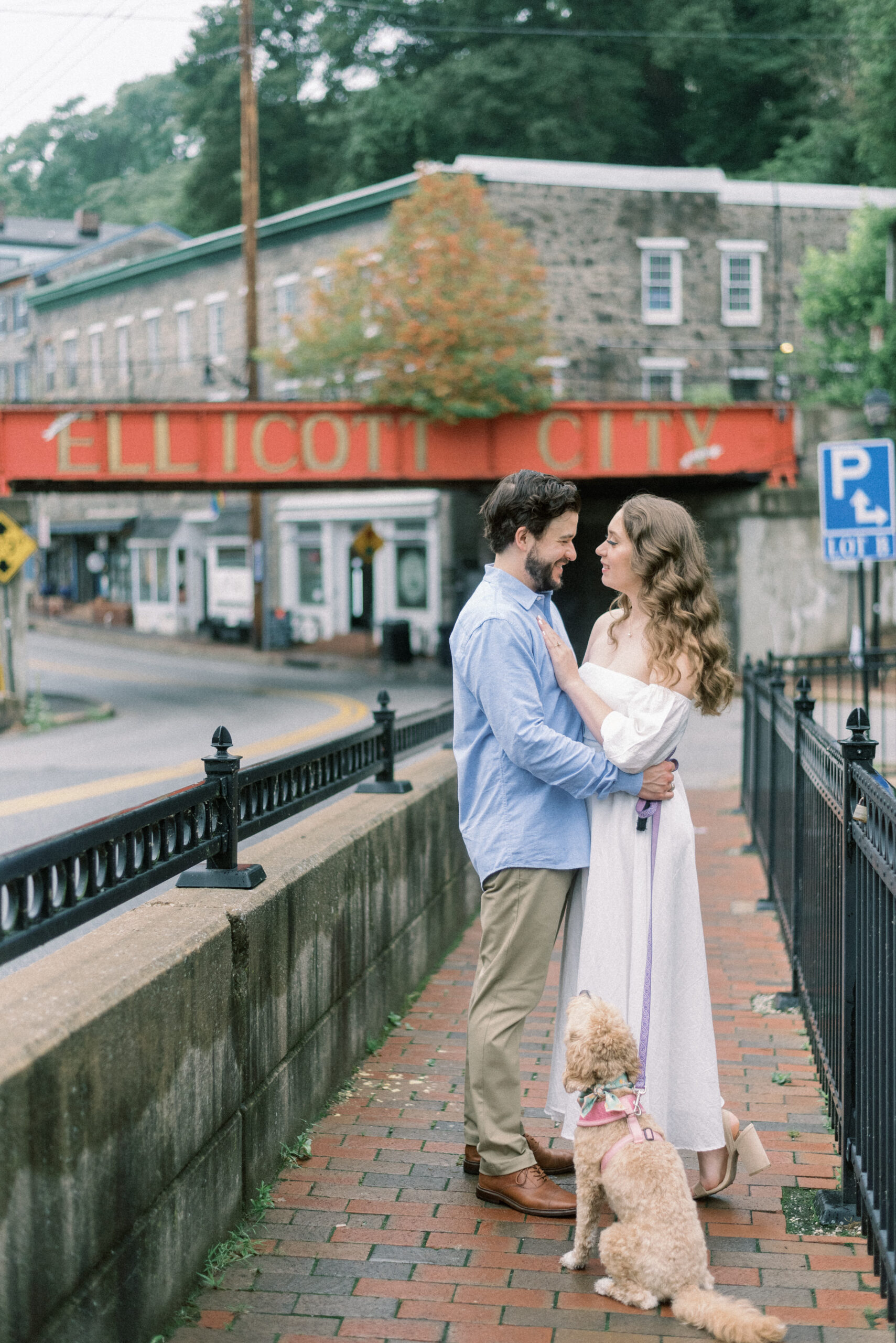Maryland wedding photographer captures man and woman hugging with puppy on leash
