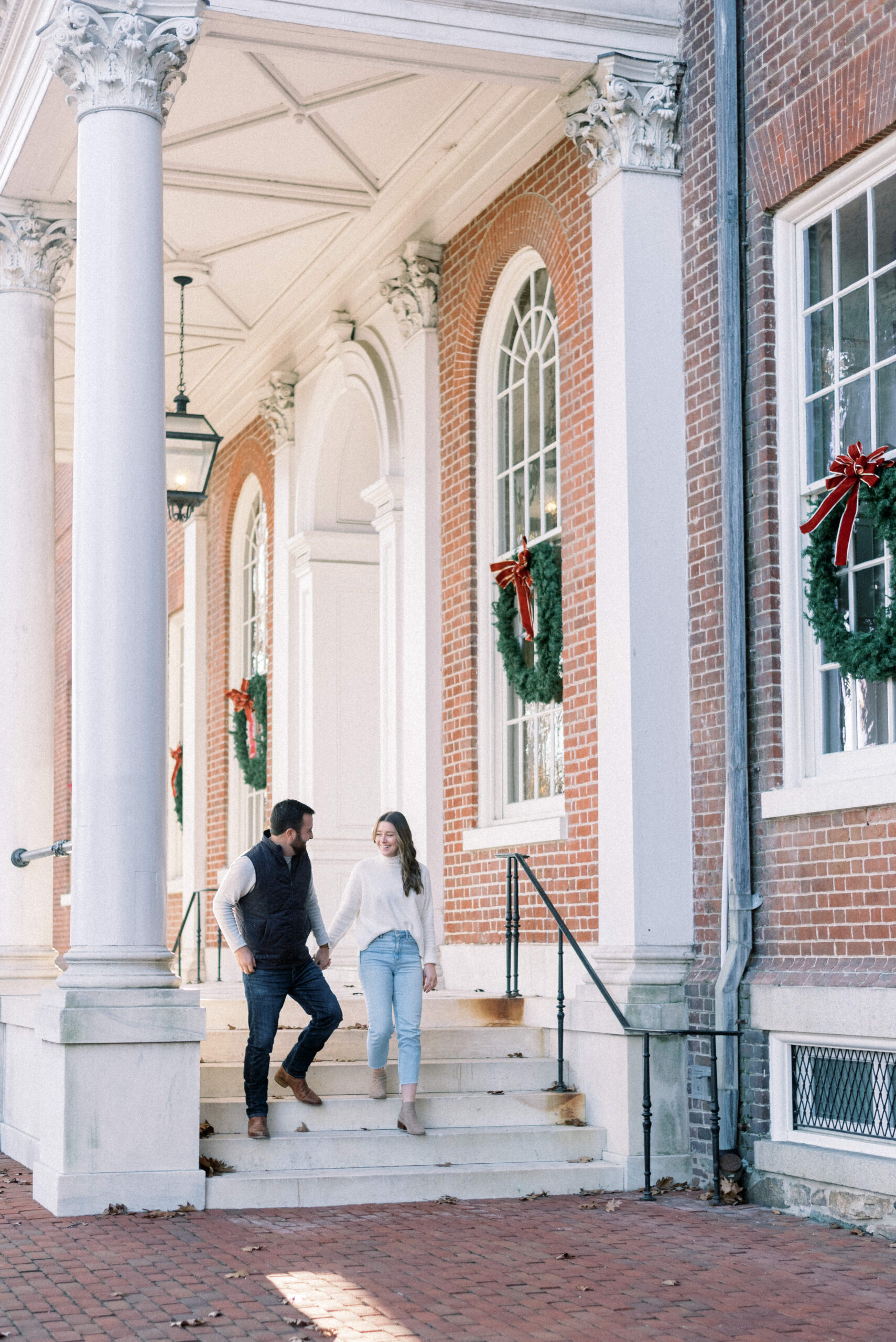 Maryland wedding photographer captures man and woman walking hand in hand downtown