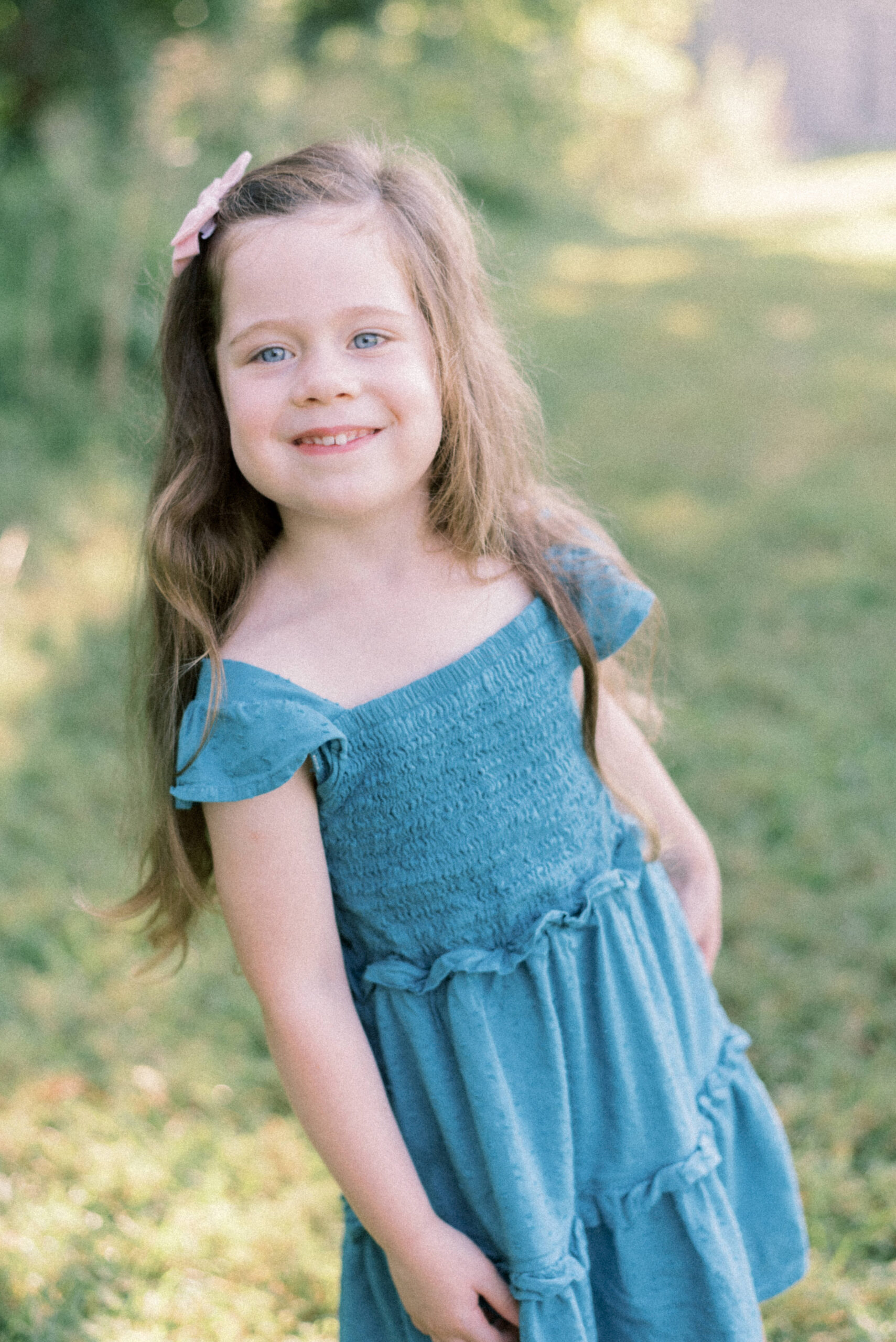 Maryland photographer captures girl smiling at camera wearing blue dress