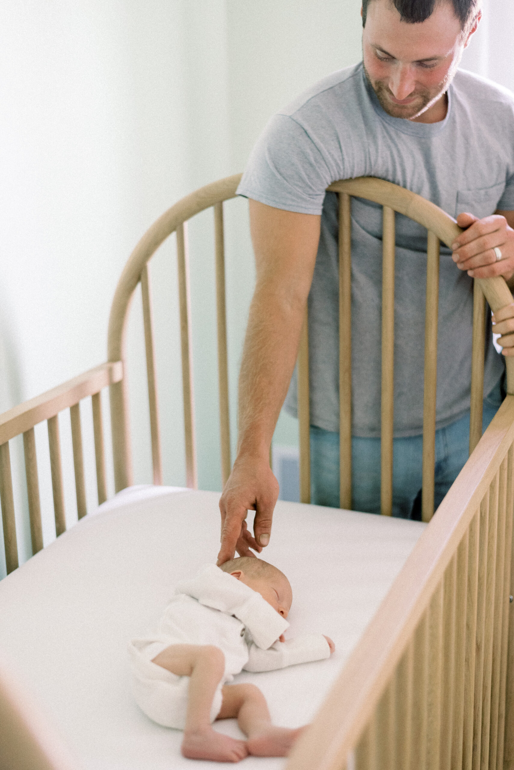 Pennsylvania photographer captures father touching baby's head while laying in crib