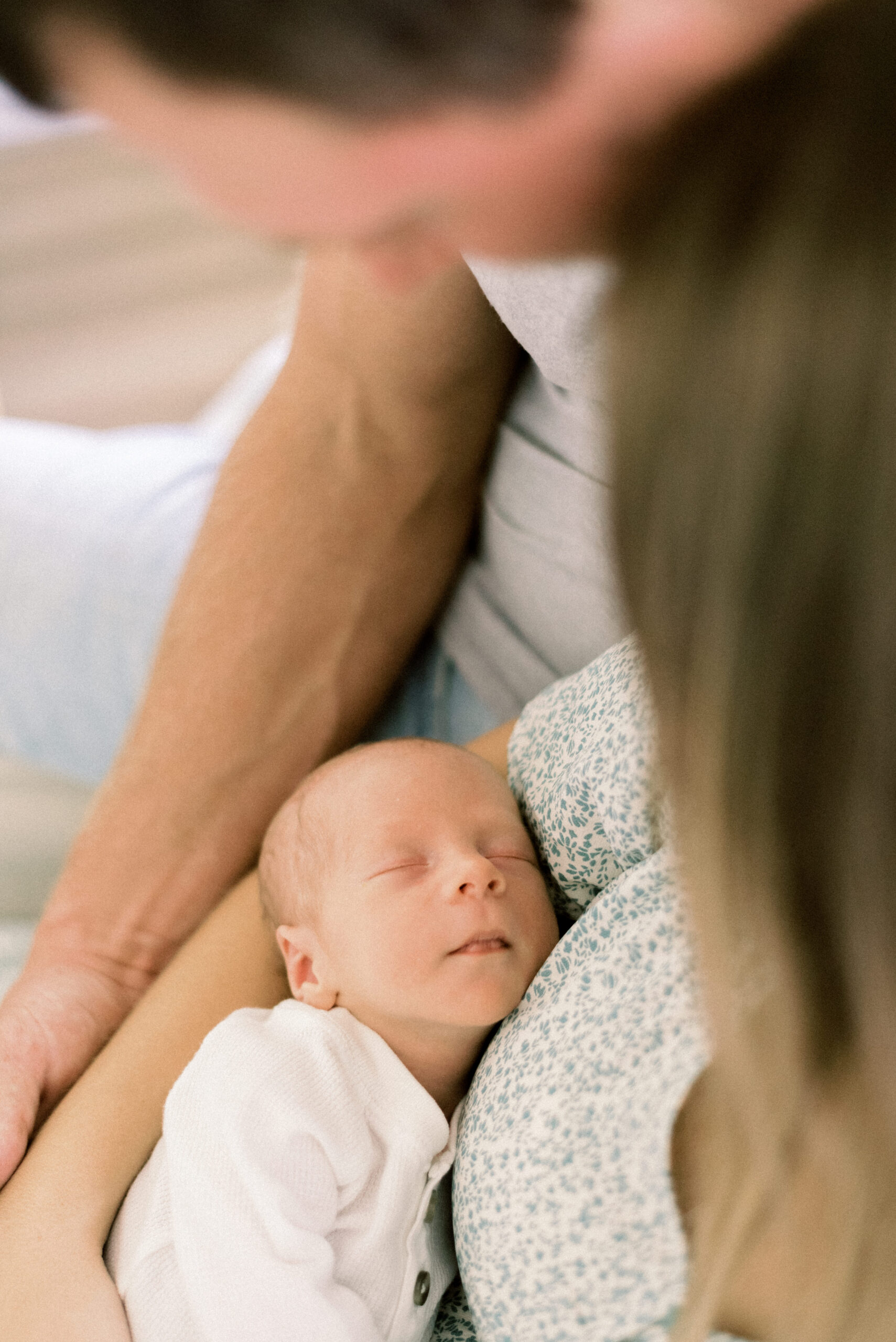 Pennsylvania photographer captures parents looking down at baby sleeping