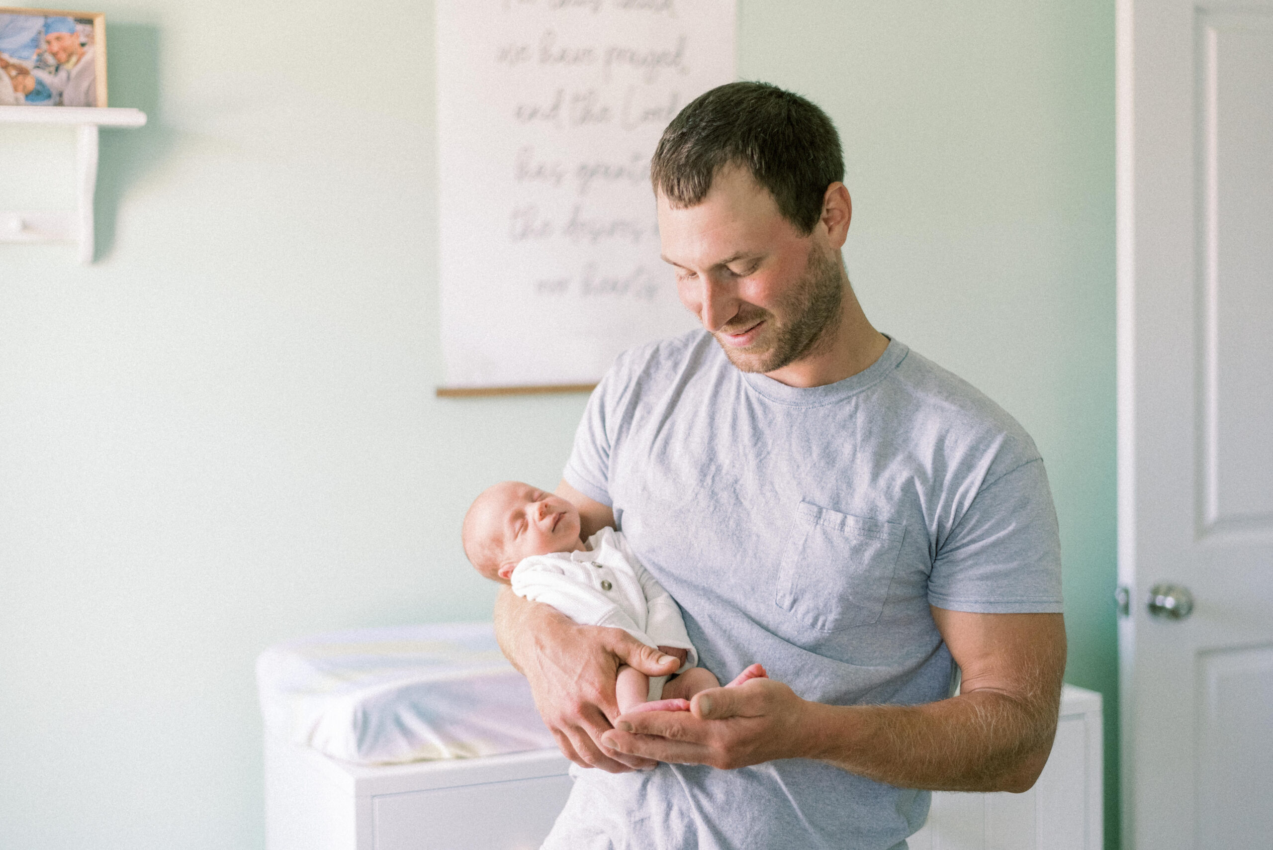 Pennsylvania photographer captures father holding baby boy during Hanover Pennsylvania newborn portraits