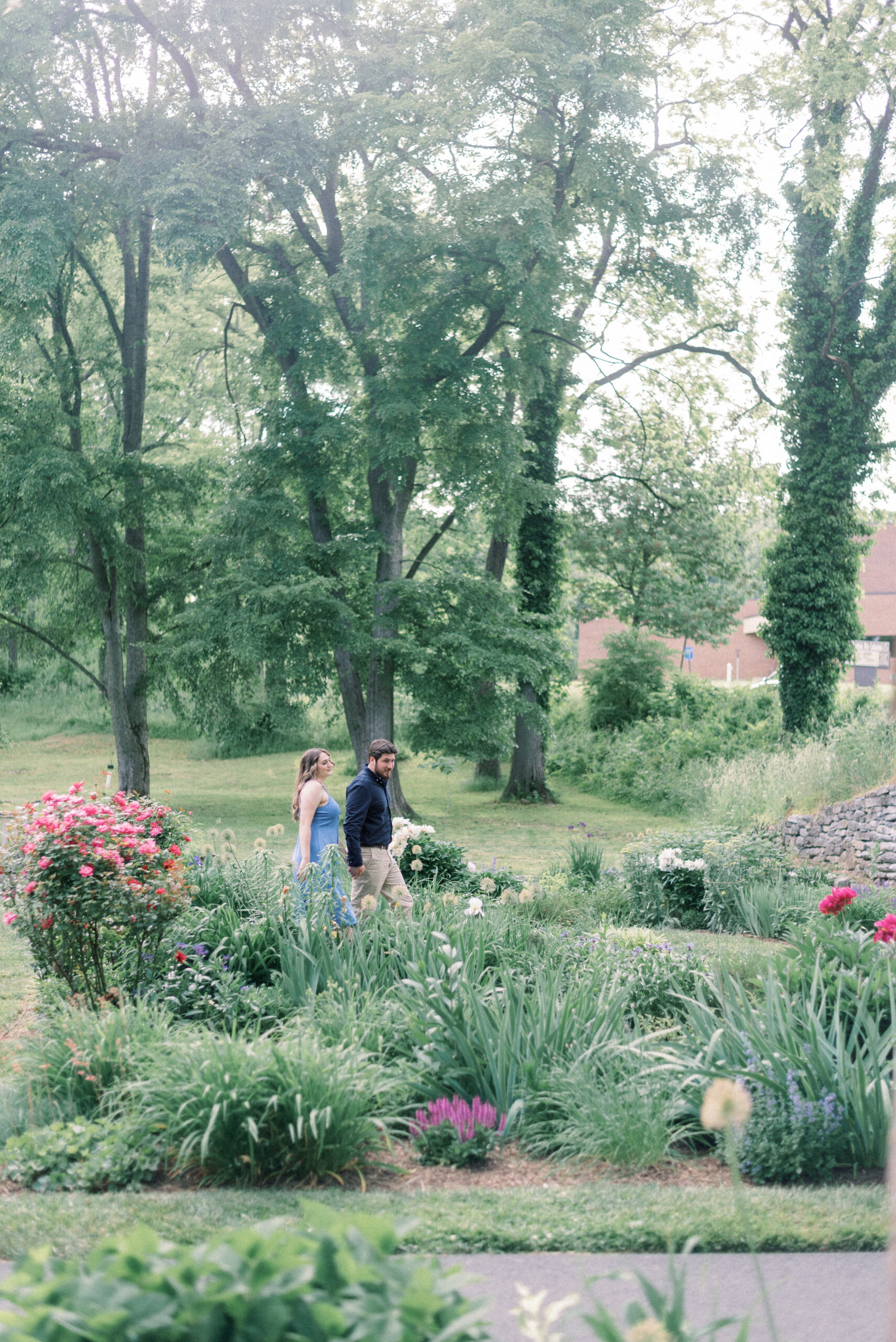 Maryland wedding photographer captures couple walking hand in hand through garden