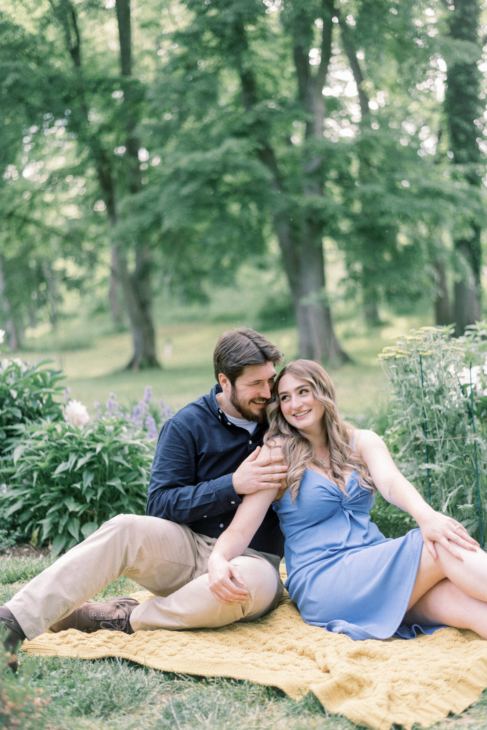Maryland wedding photographer captures man and woman sitting on blanket during engagement portraits