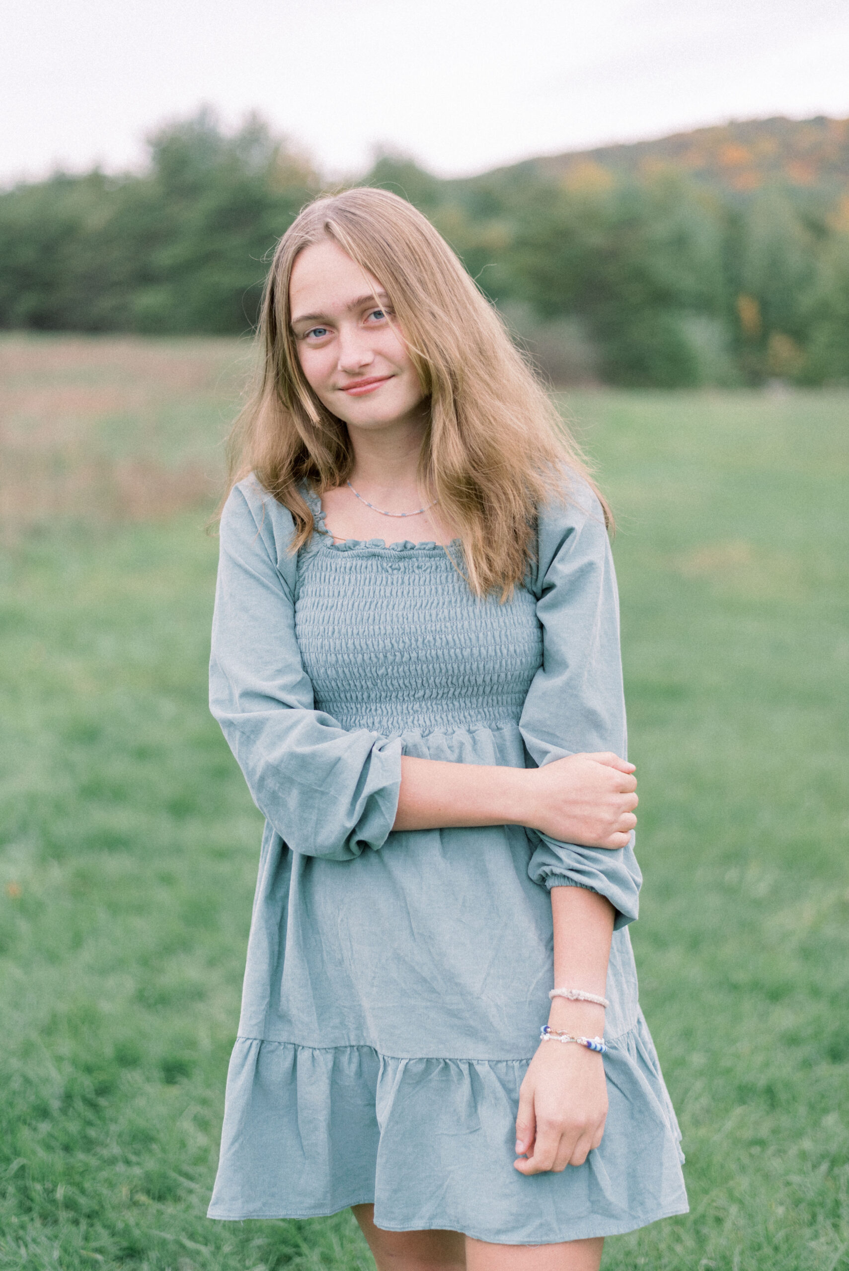Pennsylvania photographer captures young woman wearing green dress holding arm smiling at camera