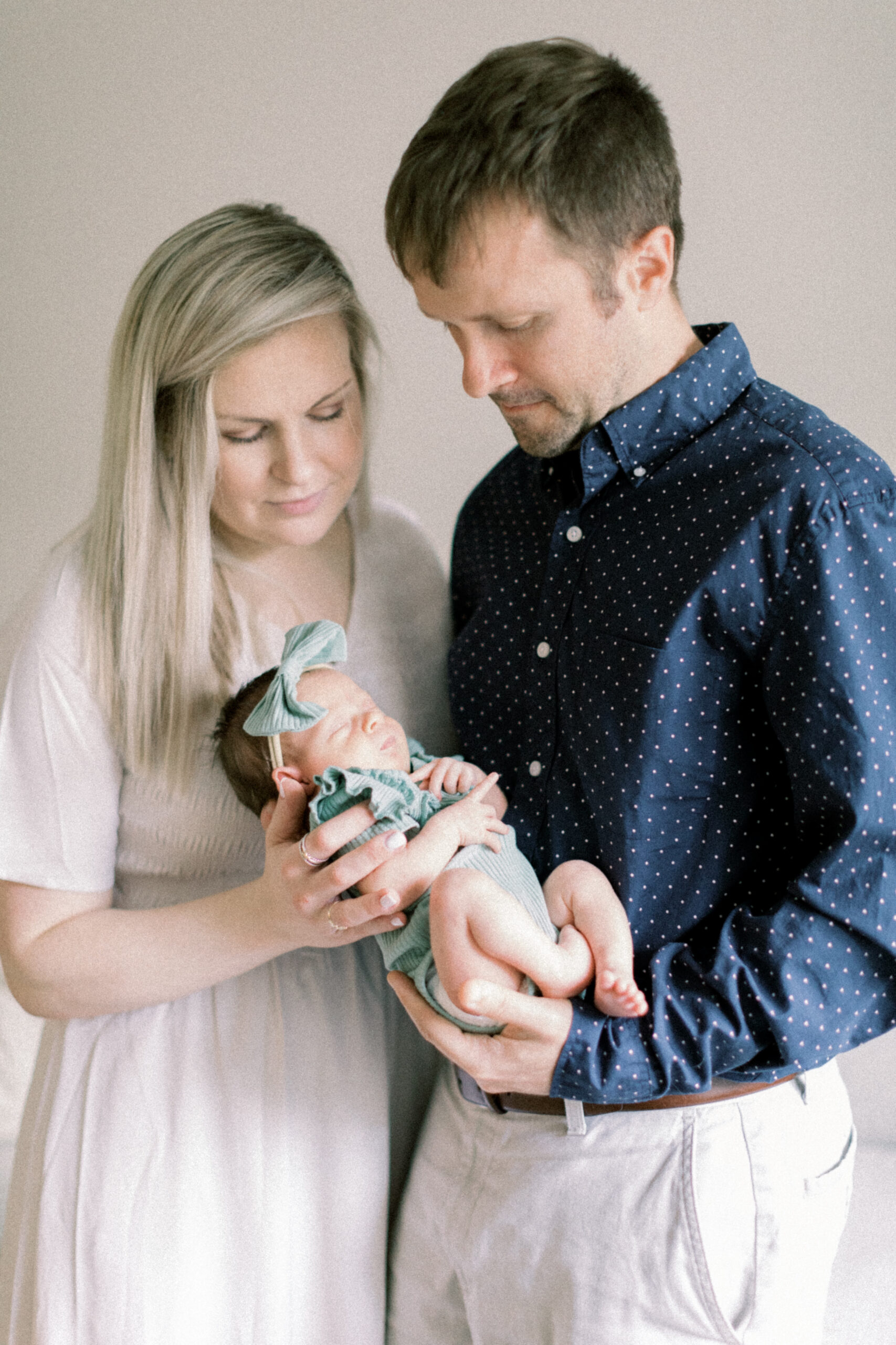 Maryland photographer captures mother and father holding newborn during Columbia at home newborn portraits