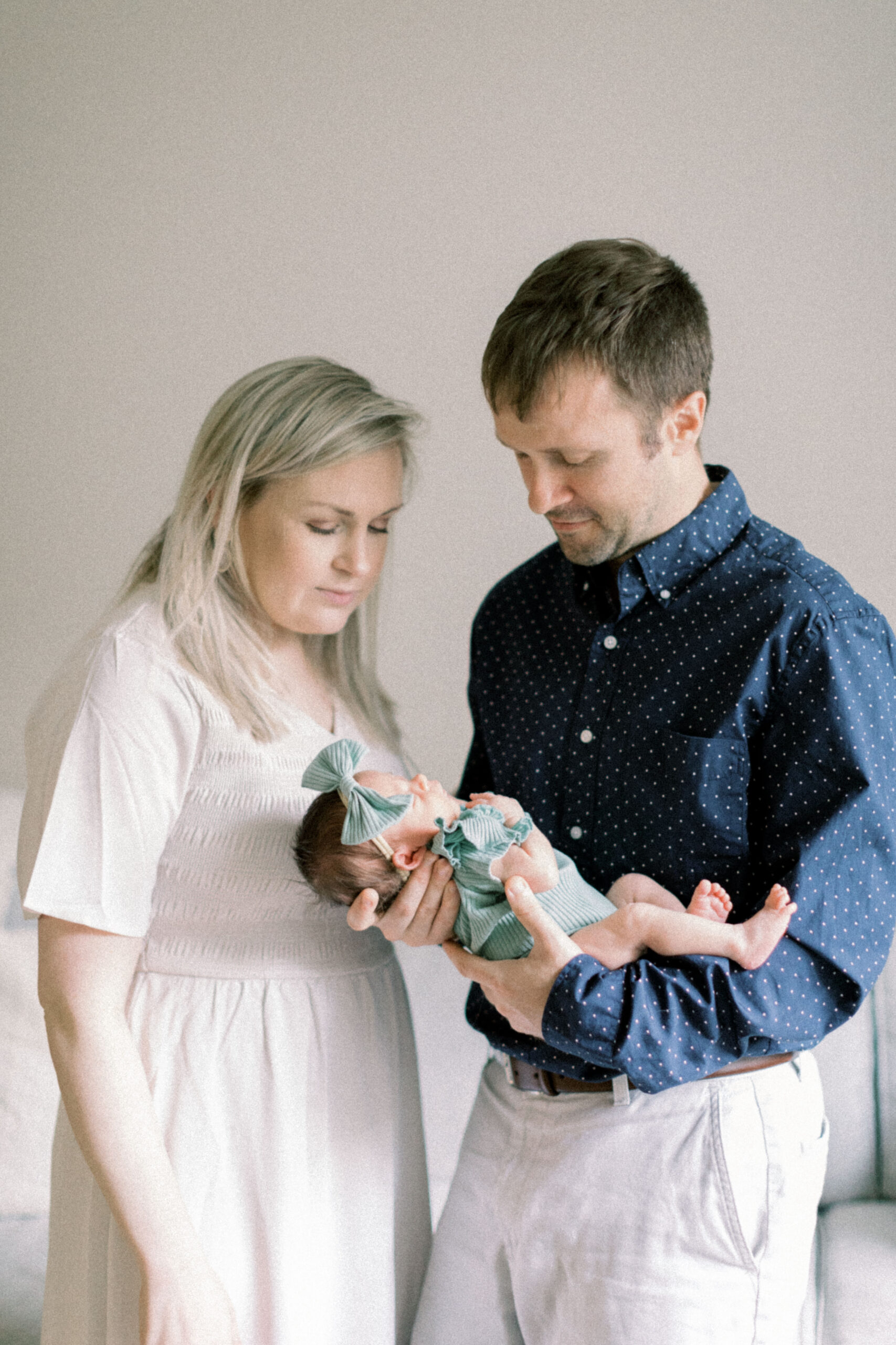 Maryland photographer captures couple looking at newborn baby