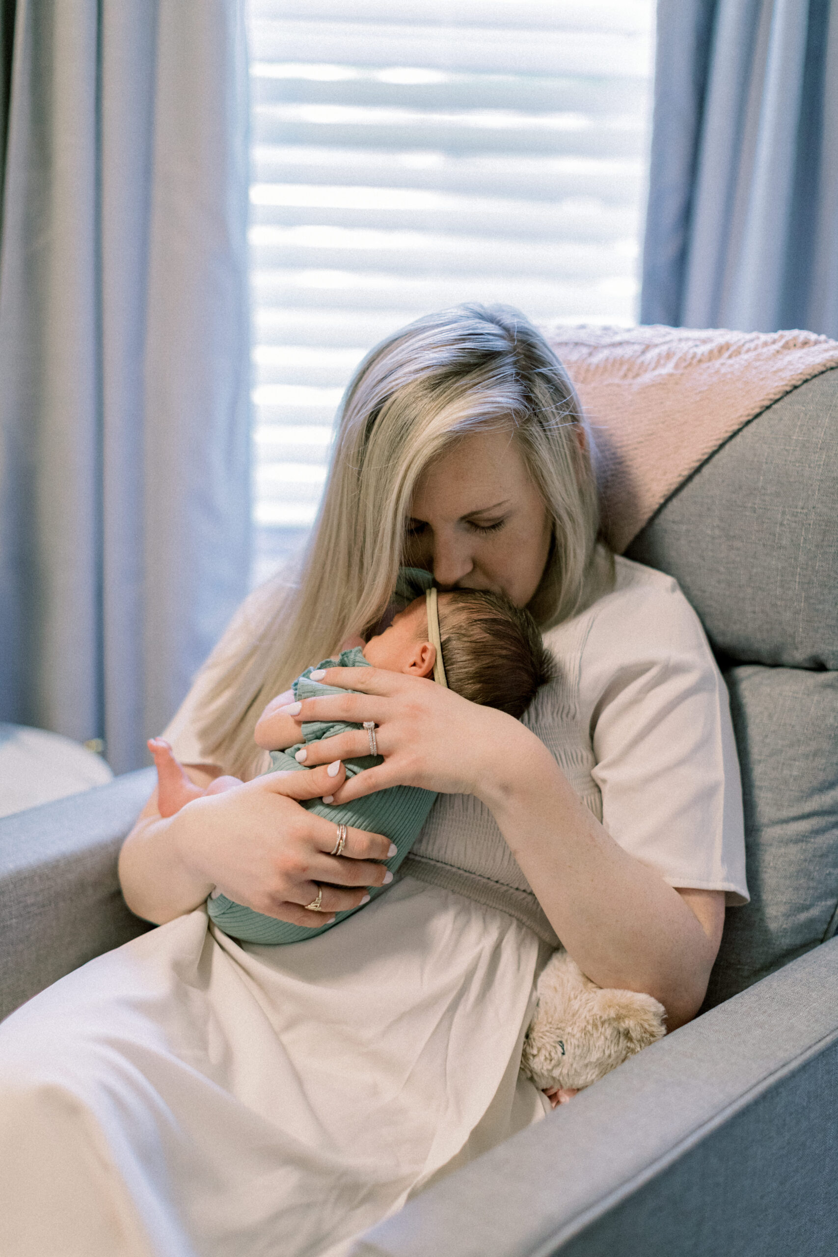 Maryland photographer captures mother rocking baby in nursery