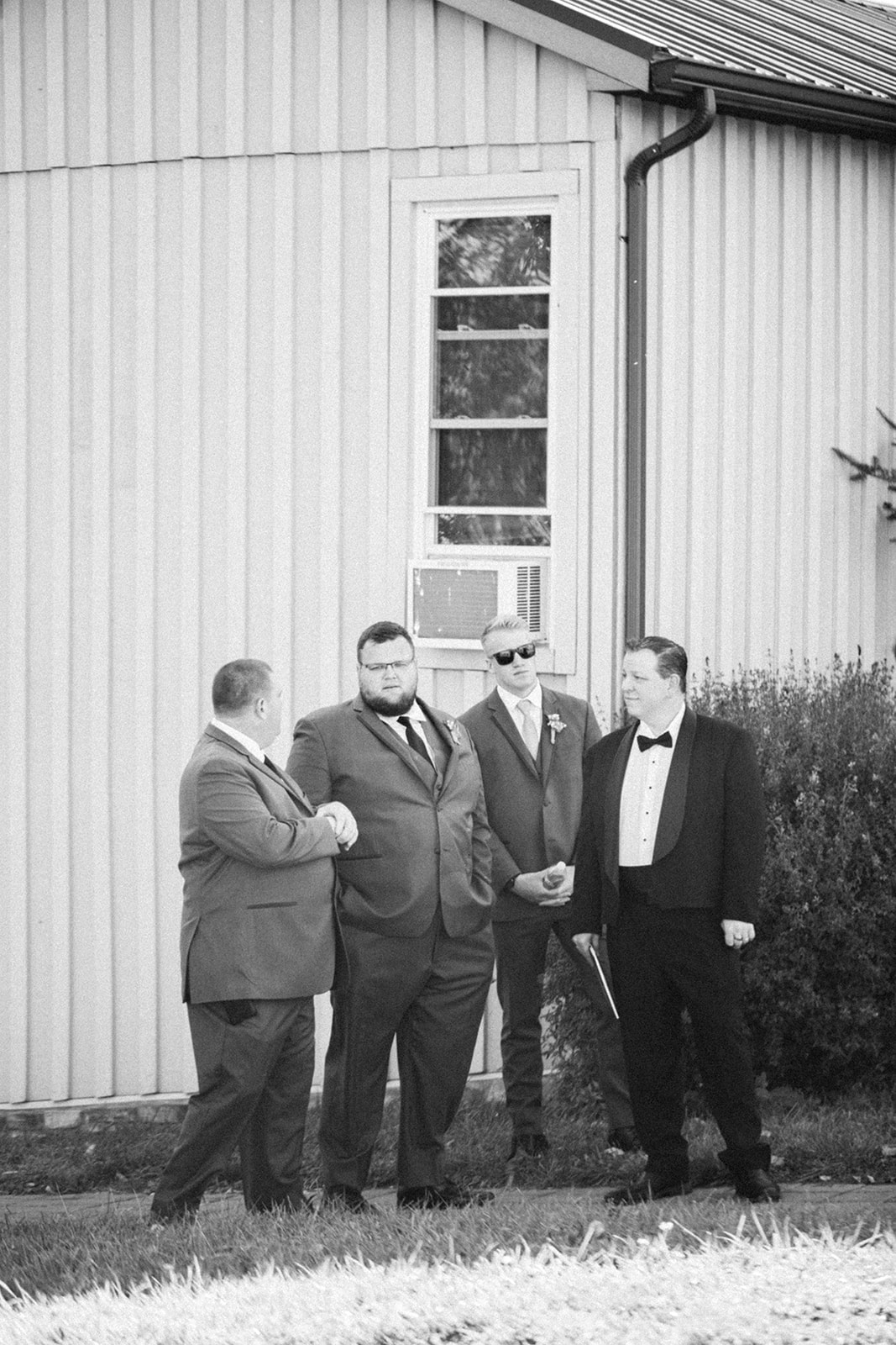 Pennsylvania wedding photographer captures black and white portrait of groomsmen outdoors