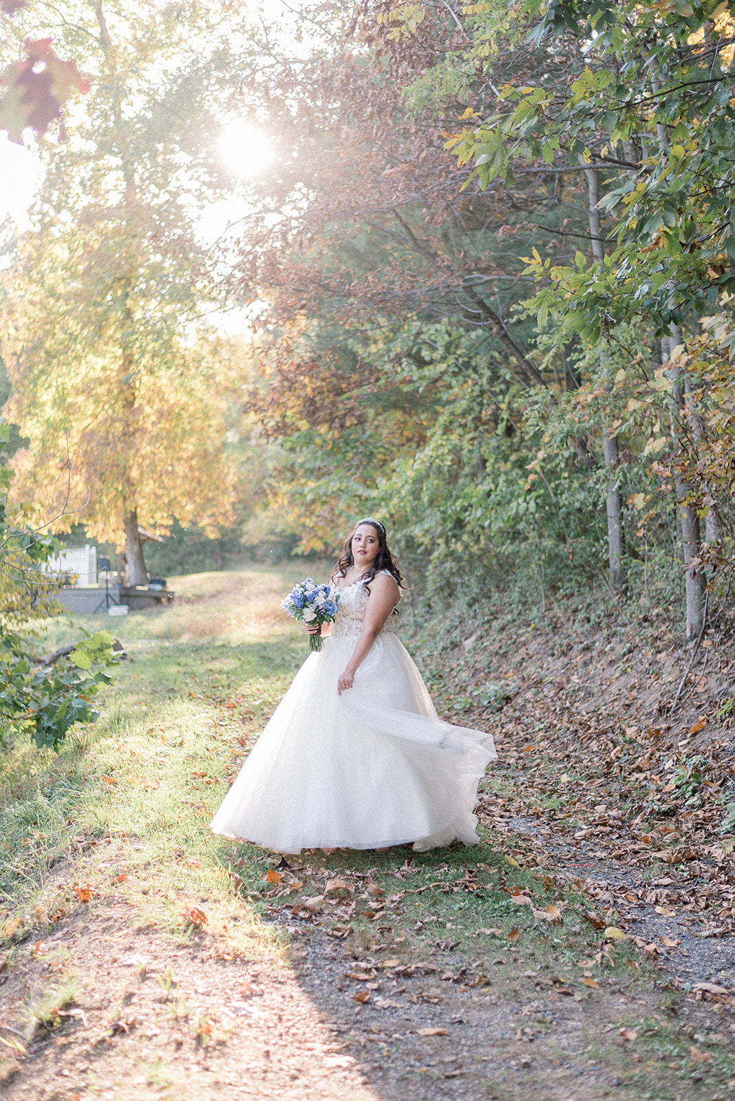 Pennsylvania wedding photographer captures bride spinning dress while holding bridal bouquet