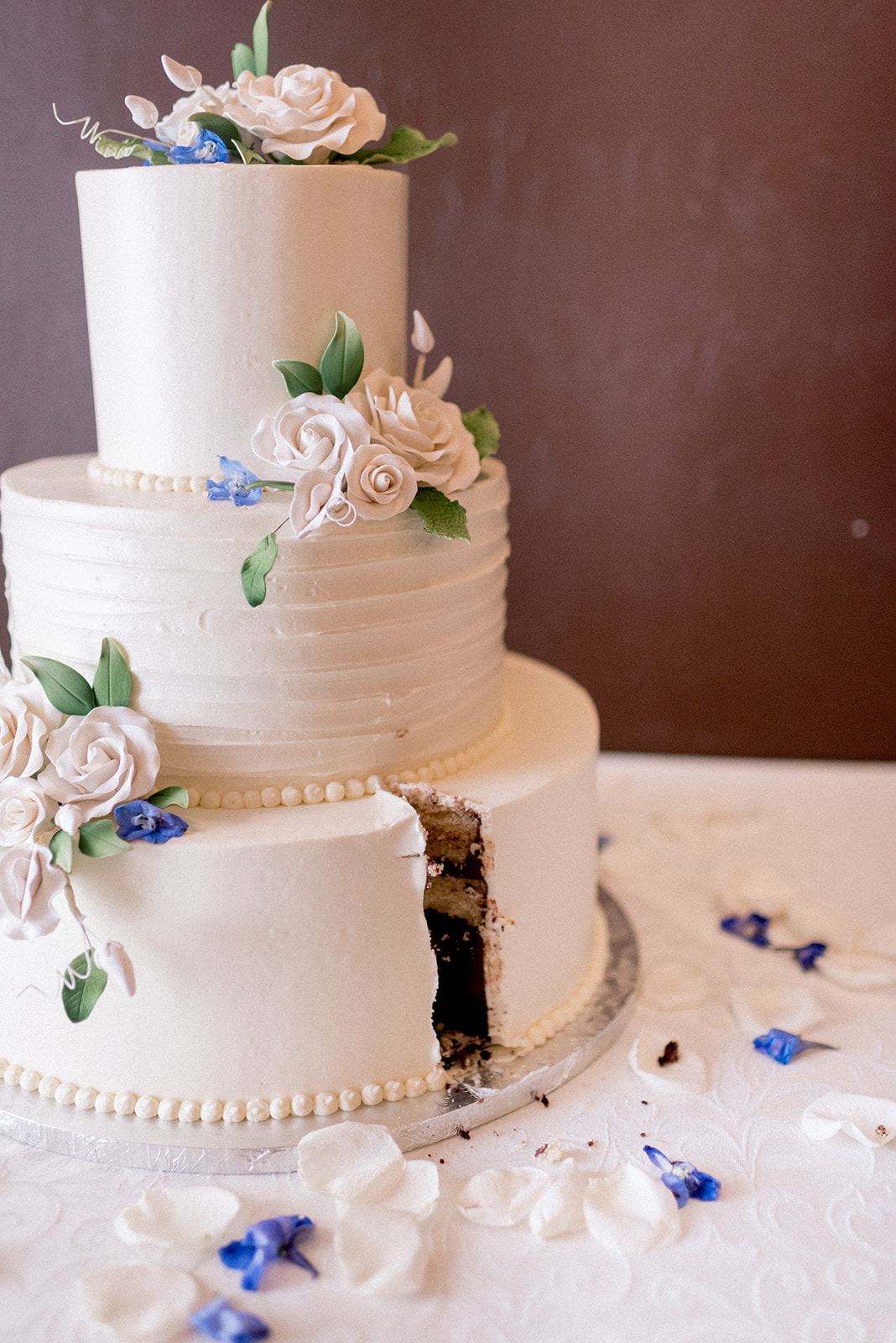 Pennsylvania wedding photographer captures three tiered wedding cake with slice cut out