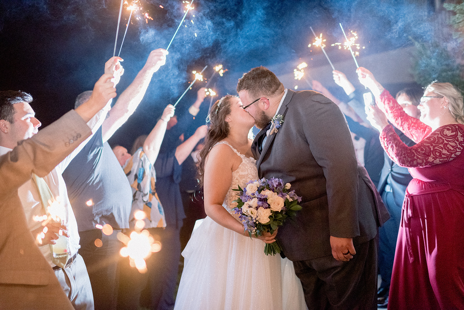 Pennsylvania wedding photographer captures sparkler exit with bride and groom kissing