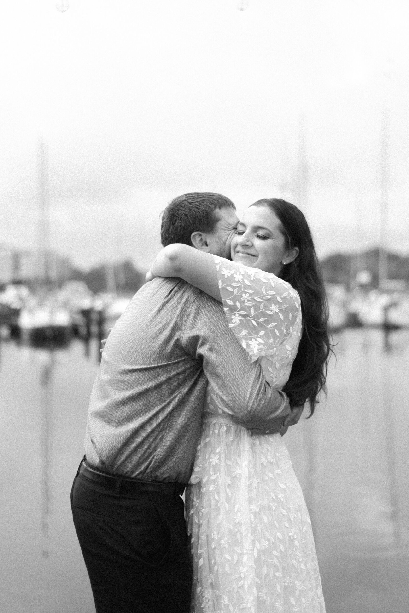 Pennsylvania wedding photographer captures black and white portrait of couple hugging during rainy engagement portraits