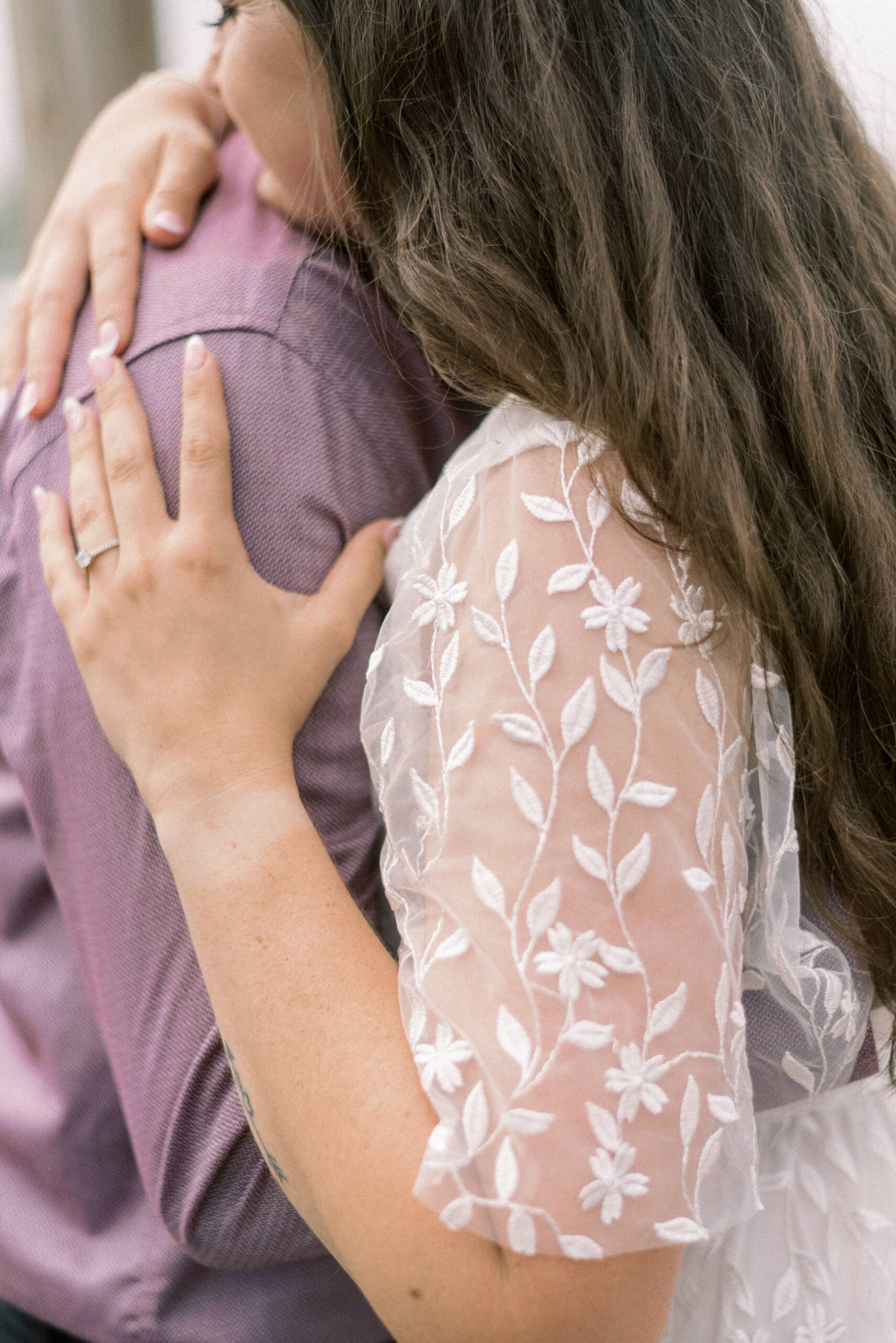 Pennsylvania wedding photographer captures woman holding mans arm with engagement ring on finger