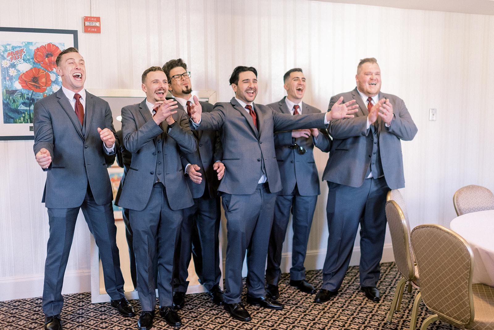 Pennsylvania wedding photographer captures groomsmen smiling and celebrating seeing bride for first time