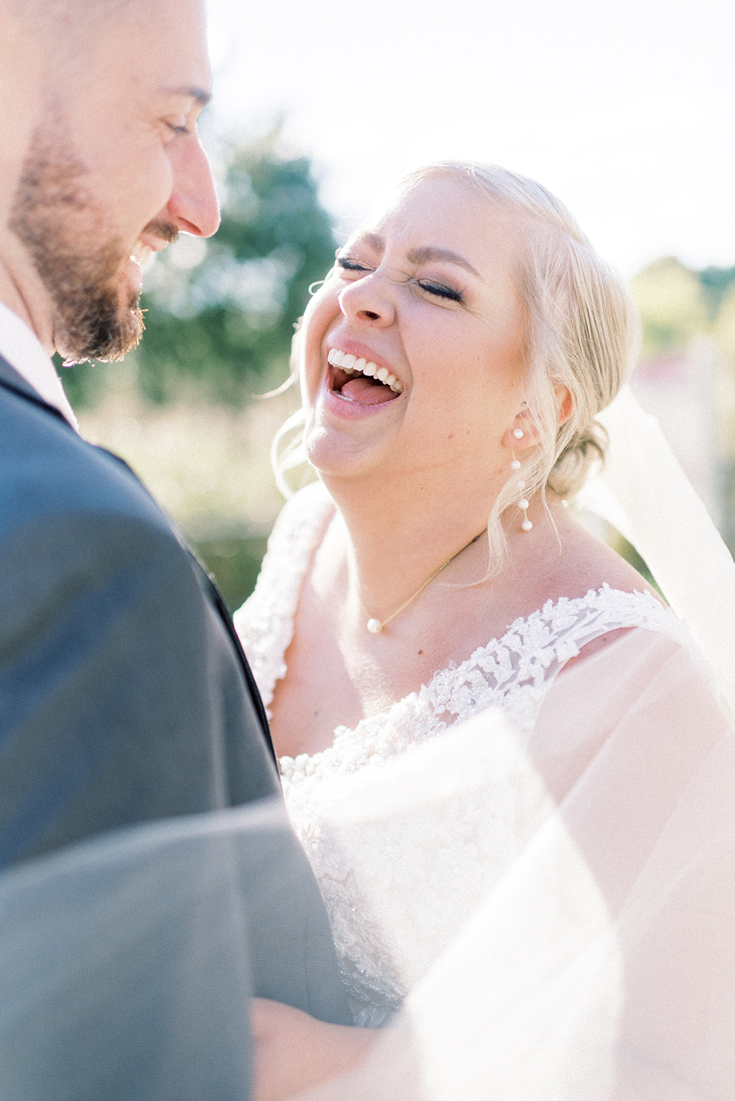 Pennsylvania wedding photographer captures bride laughing during outdoor bridal portraits