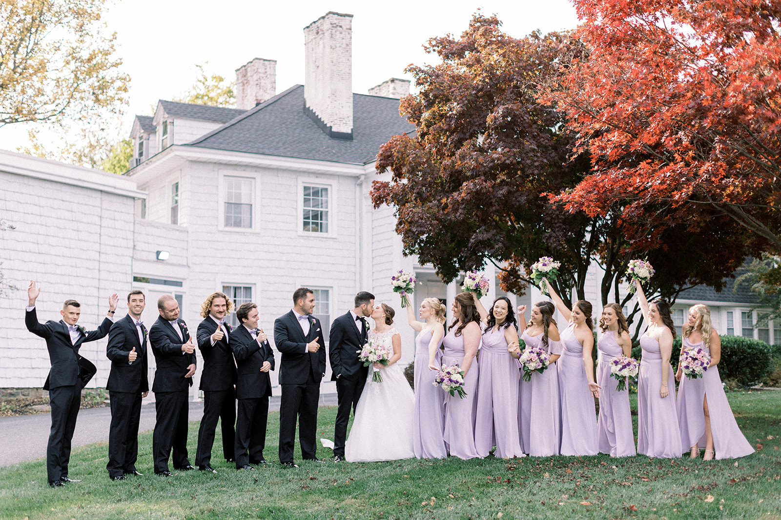 Pennsylvania wedding photographer captures wedding party celebrating bride and groom kiss