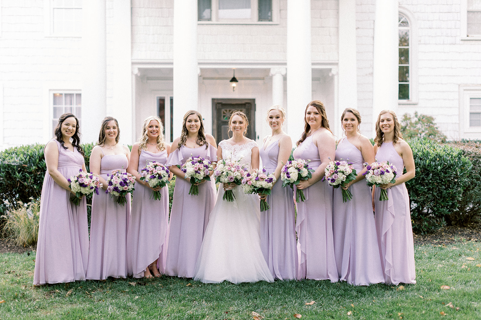 Pennsylvania wedding photographer captures bride with bridesmaids wearing purple dresses