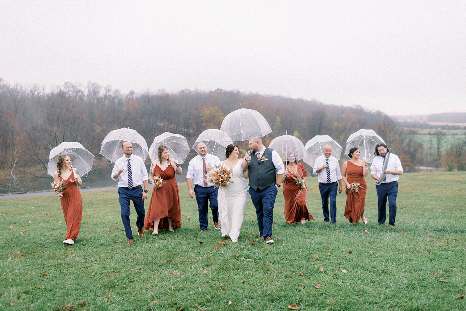 Pennsylvania wedding photographer captures bride and groom walking together with umbrella