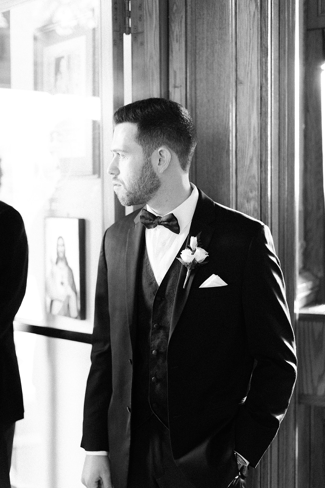 Pennsylvania wedding photographer captures black and white portrait of groom looking into wedding ceremony space