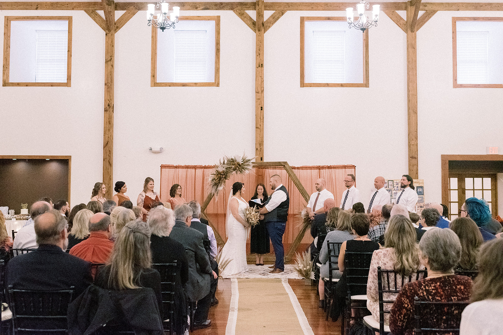 Pennsylvania wedding photographer captures bride and groom holding hands at wedding ceremony
