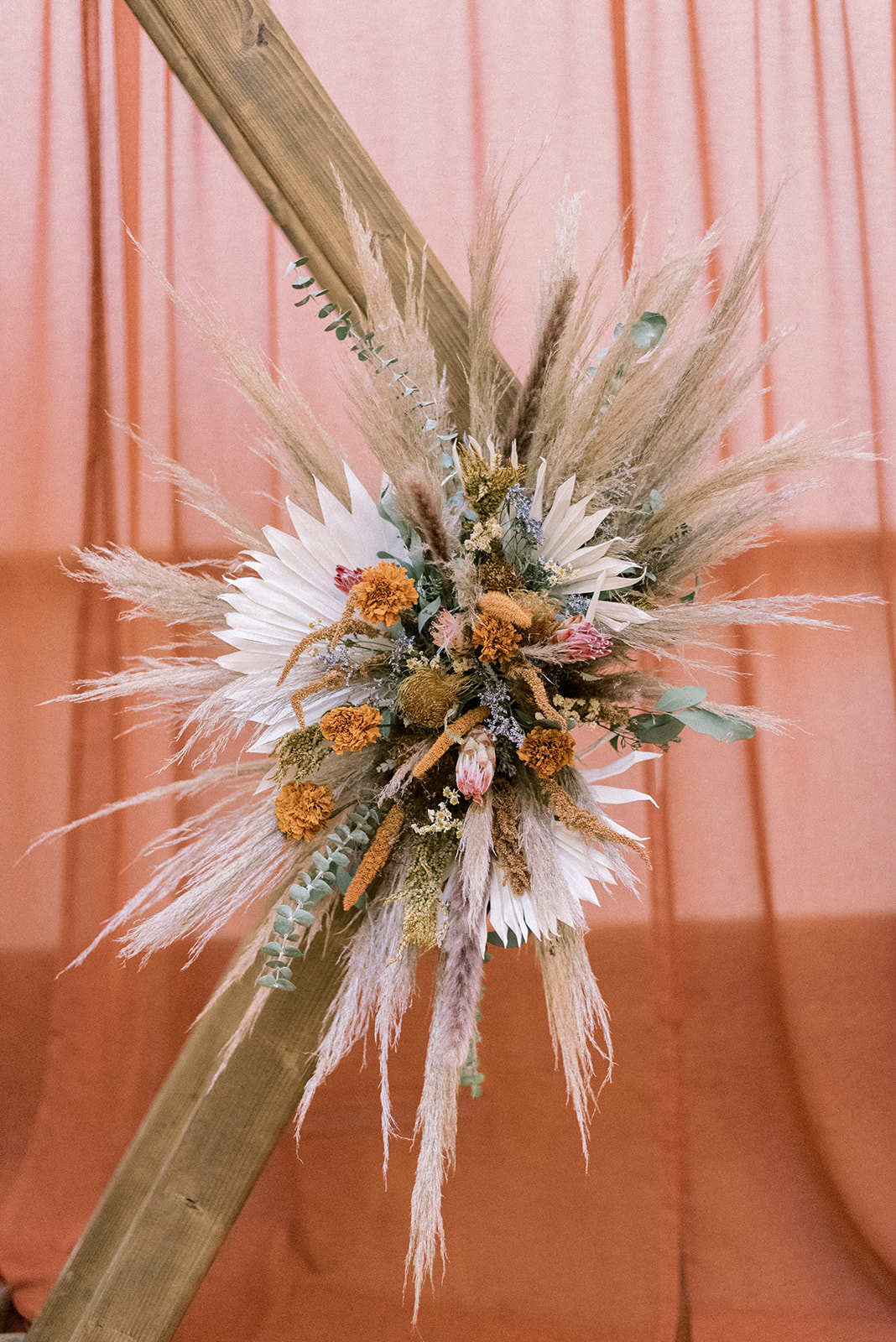 Pennsylvania wedding photographer captures wedding floral arrangements with rust flowers and pampas grass