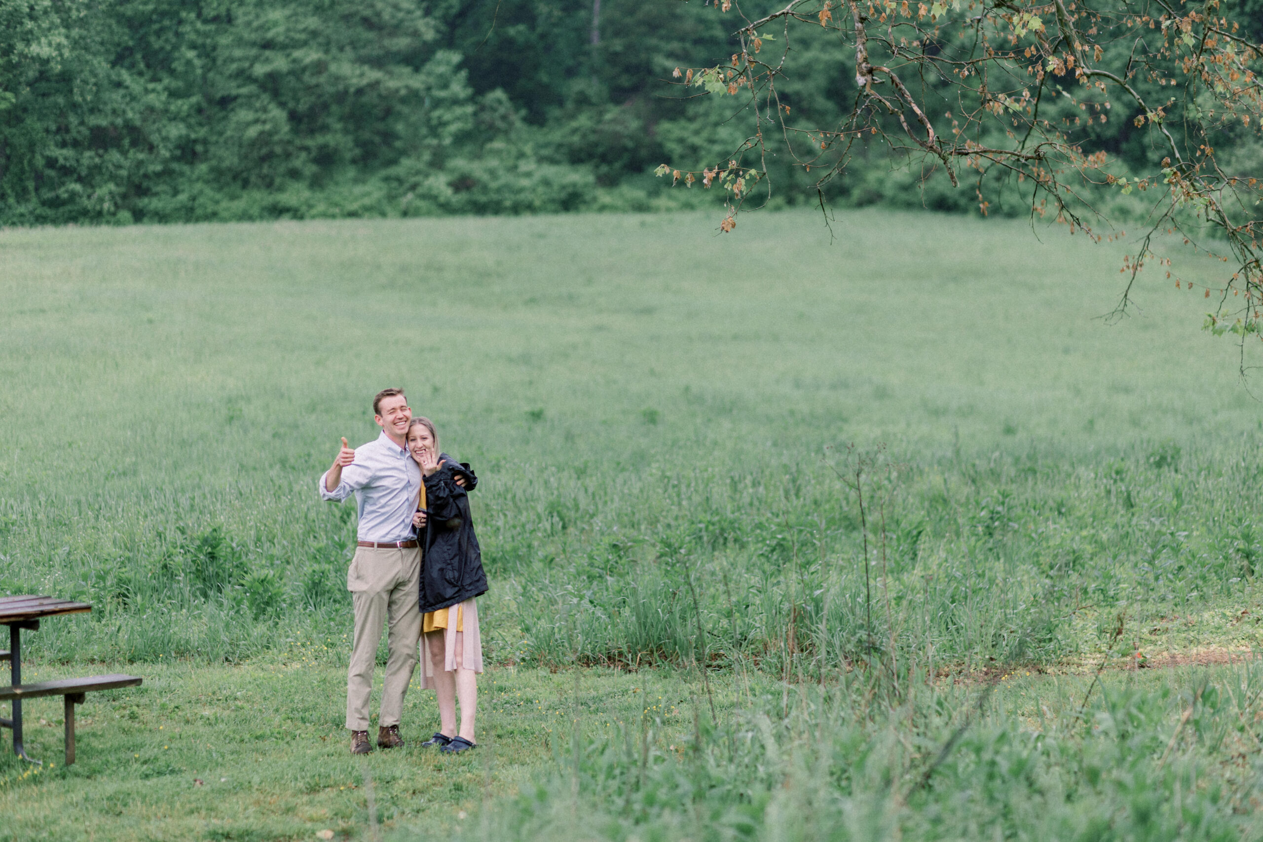 Pennsylvania wedding photographer captures couple smiling, showing engagement ring and giving thumbs up